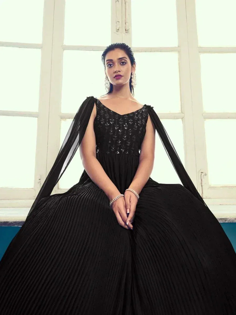Elegant black ethnic gown with sequin bodice and pleated skirt, perfect for festive occasions.