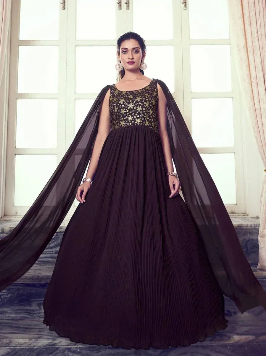 Elegant black ethnic gown with gold embroidery and sheer cape, perfect for weddings and parties.