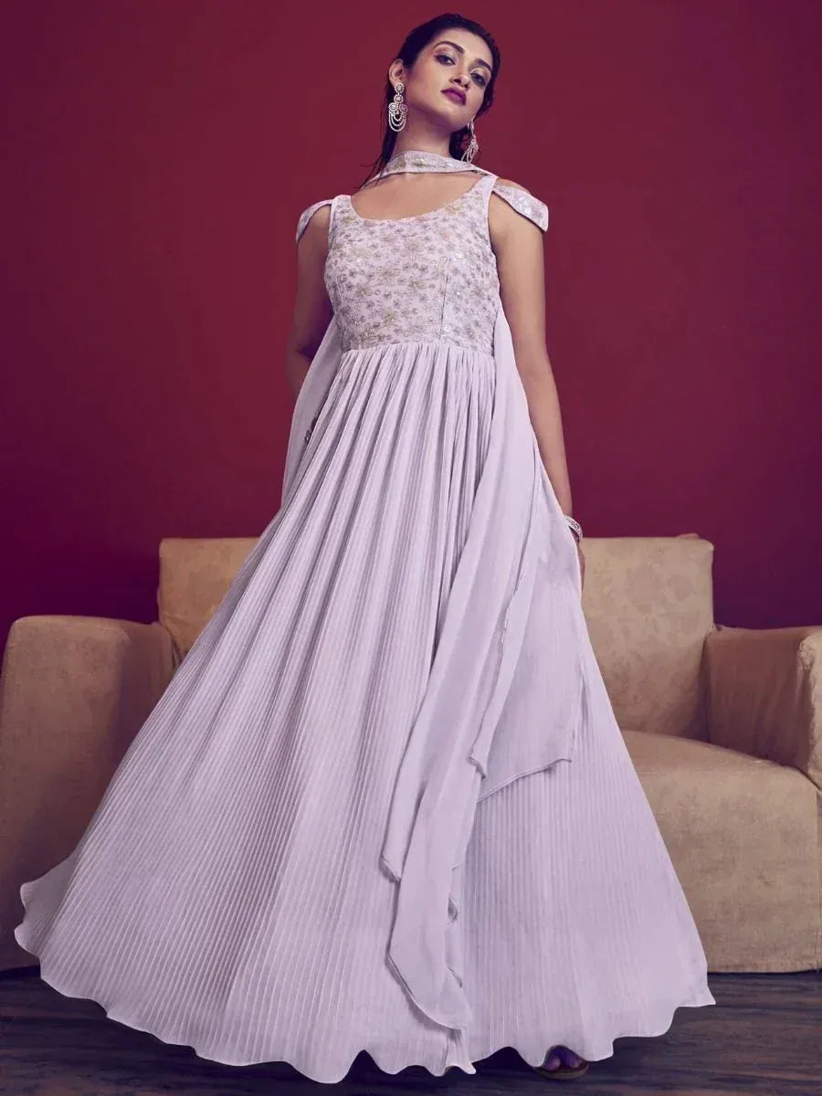 Elegant lavender ethnic gown with floral embroidery and pleated skirt, perfect for Indian occasions
