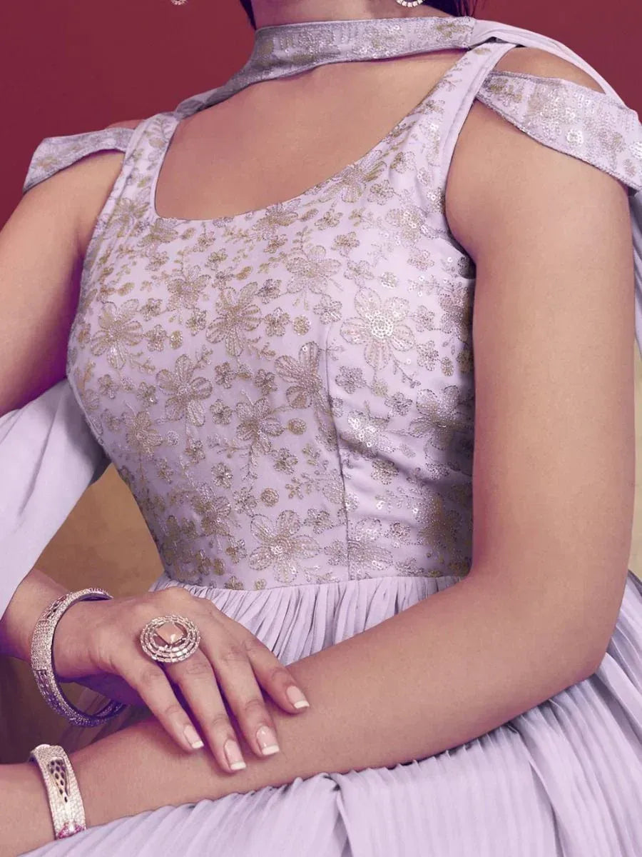 Lavender ethnic gown with gold floral embroidery and cold shoulder detail, perfect for Indian occasions