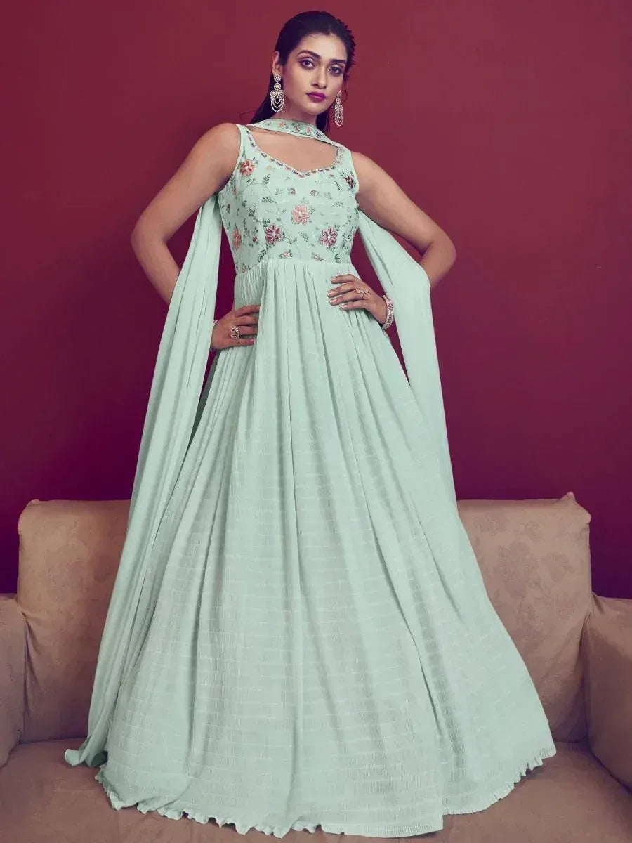 Mint green floral embroidered ethnic gown with cape sleeves, perfect for Indian occasions and weddings.
