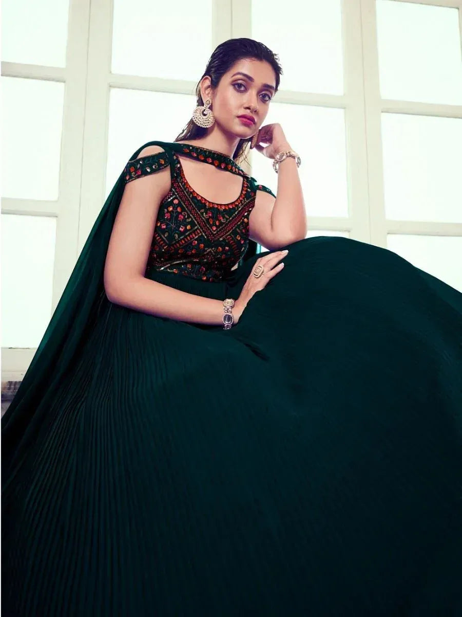 Elegant dark green ethnic gown with embroidered bodice and pleated skirt, perfect for Indian occasions.