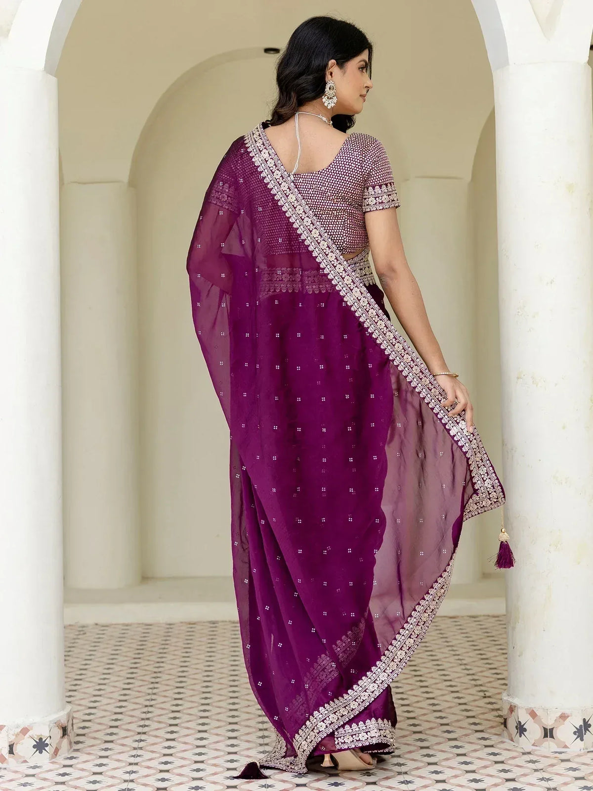 Purple embroidered saree with white border, styled with blouse and tassels, perfect for ethnic occasions