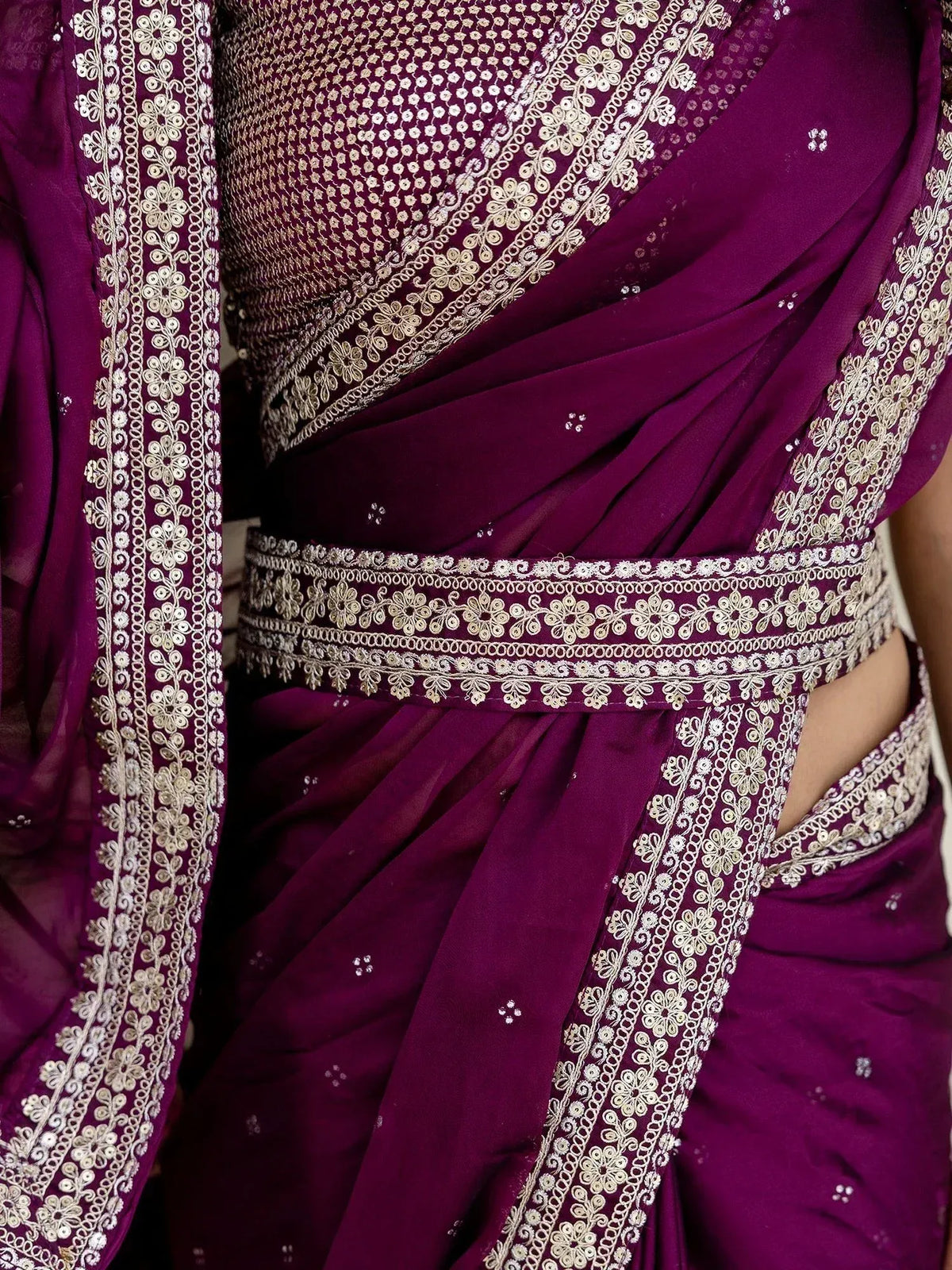 Purple designer saree with gold floral embroidery and sequin detailing, perfect for ethnic occasions