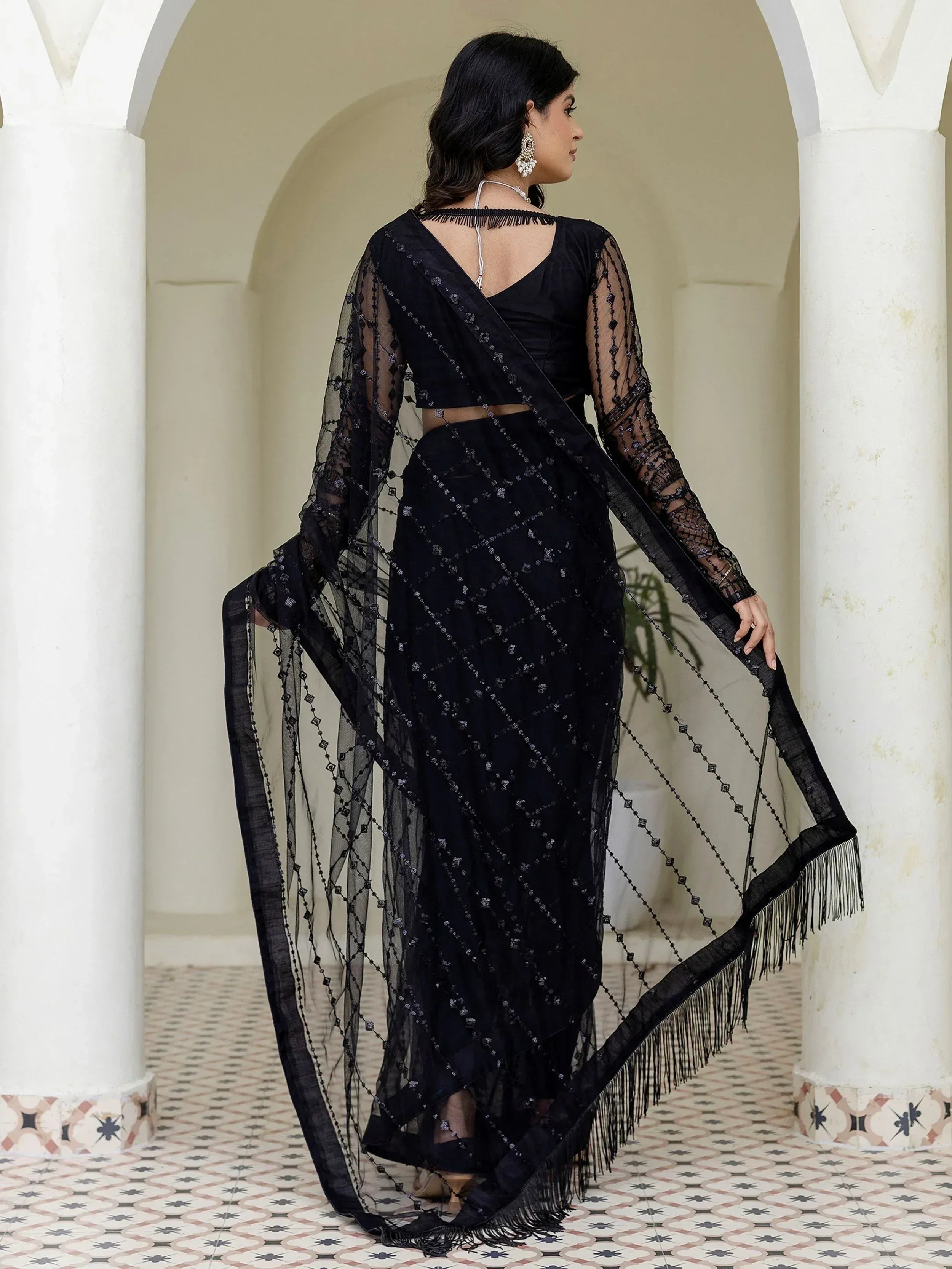 Black embroidered saree with sheer sleeves and fringe, elegant Indian ethnic wear for women