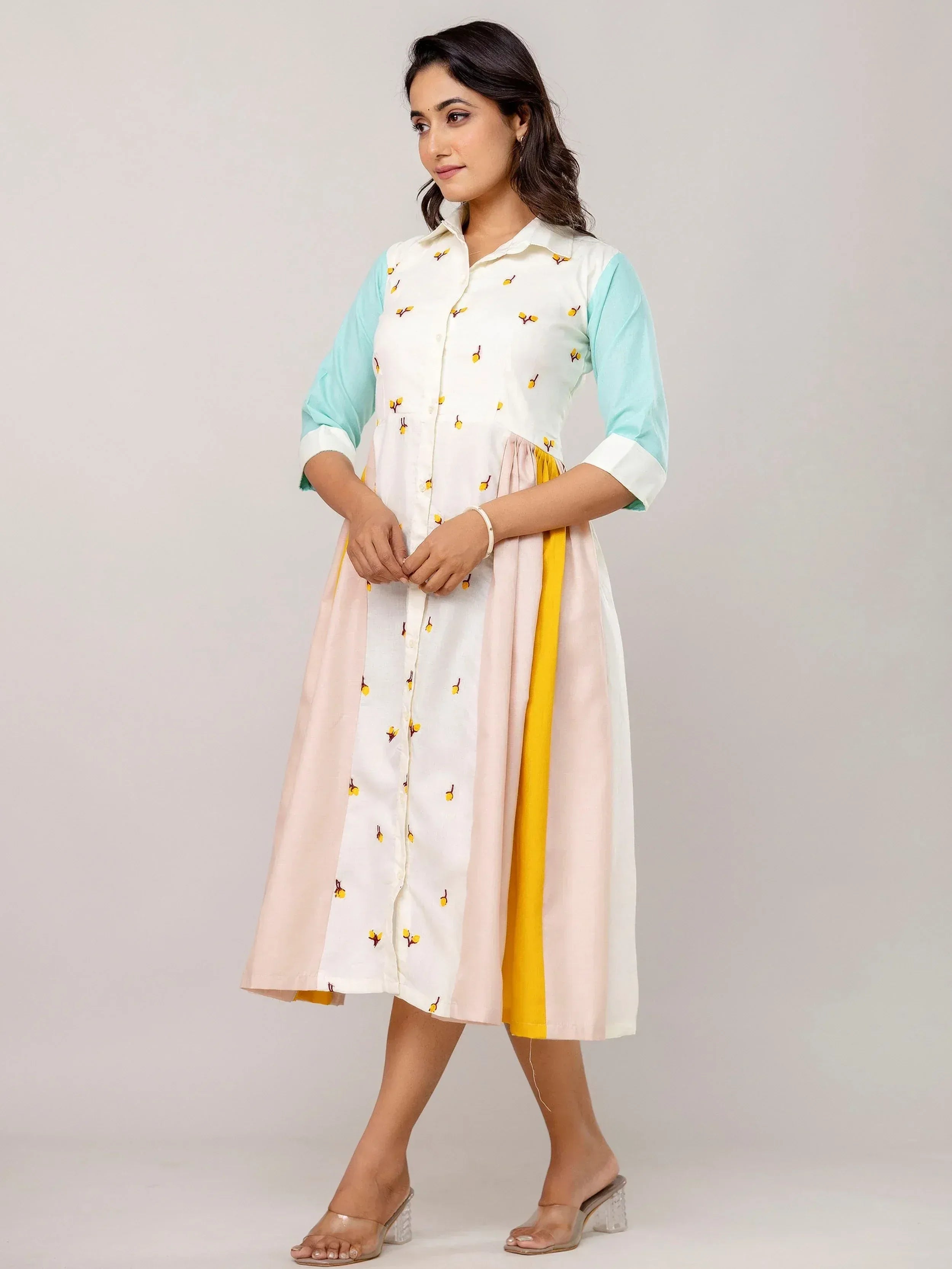 Woman in embroidered white and mint ethnic kurta with pink-yellow panel, styled for Indian wear