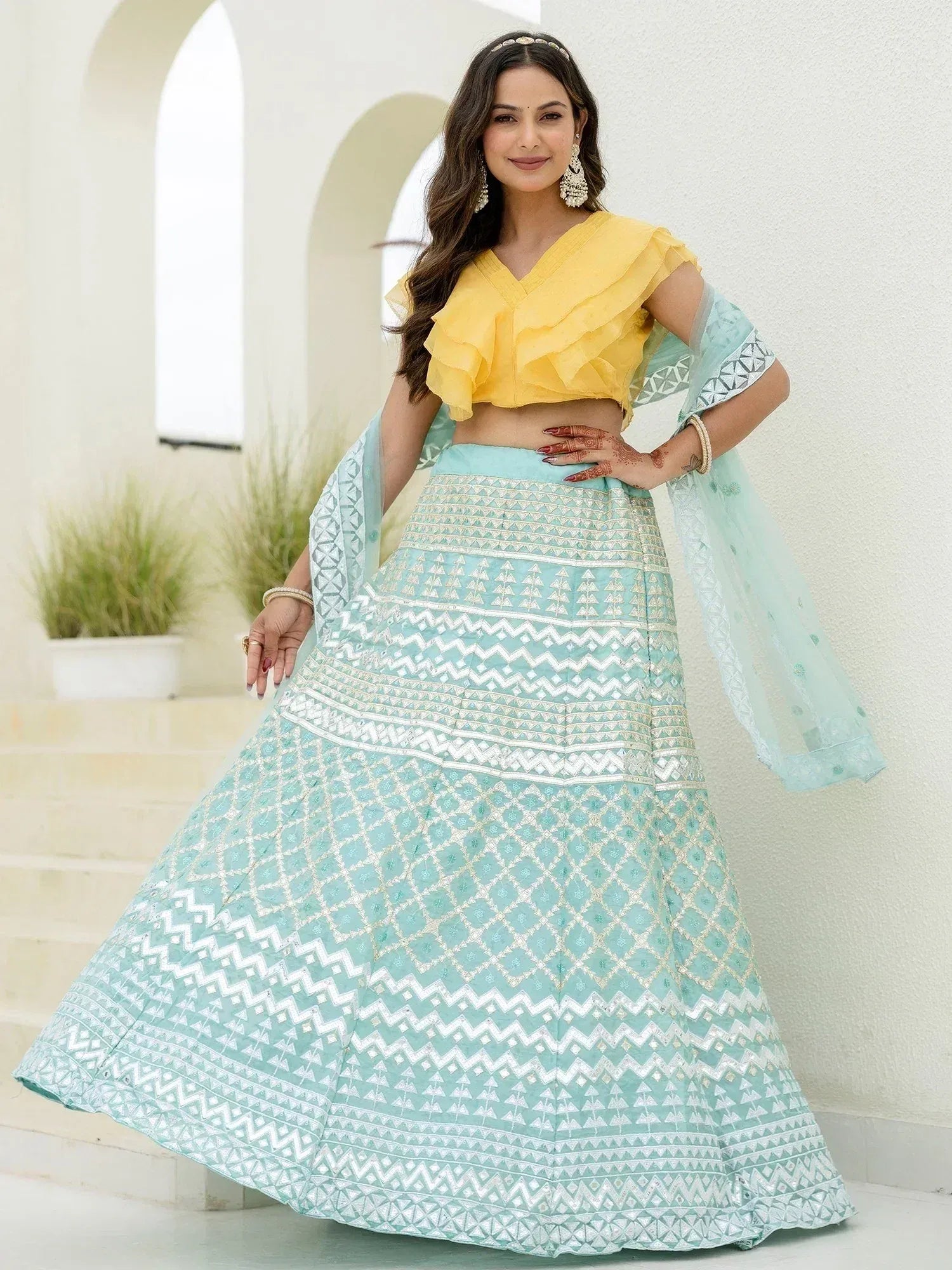 Yellow ruffle crop top with mint blue embroidered lehenga choli, perfect for Indian ethnic wear occasions