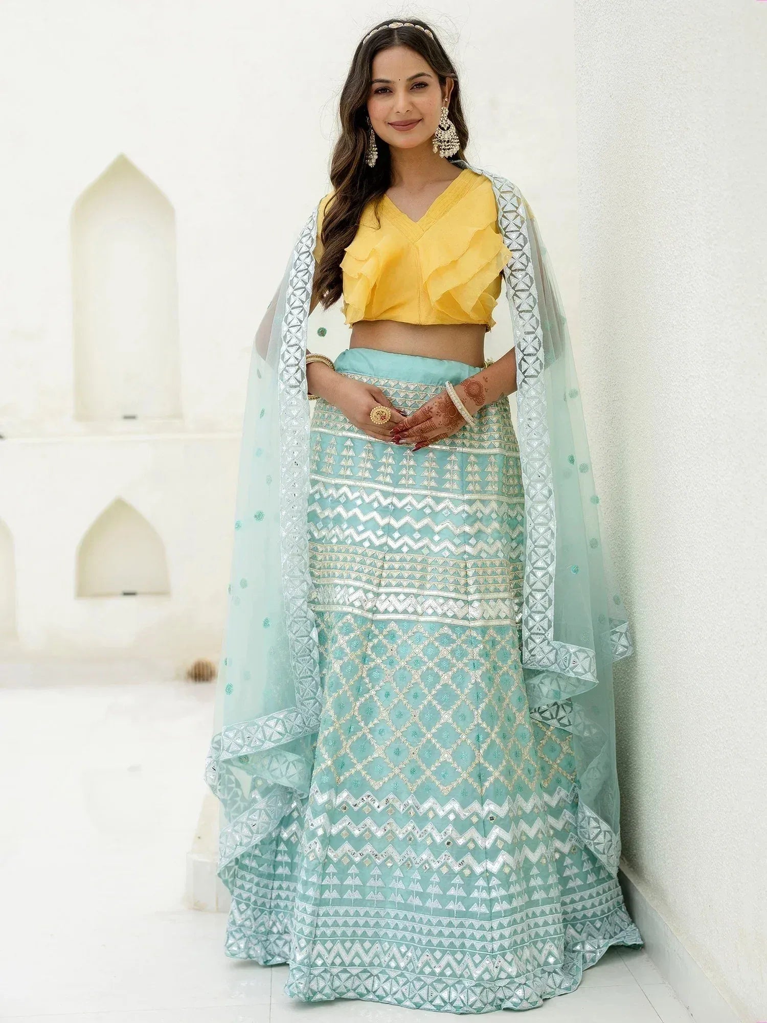 Yellow ruffle crop top with mint green embroidered lehenga and dupatta, perfect for Indian ethnic occasions