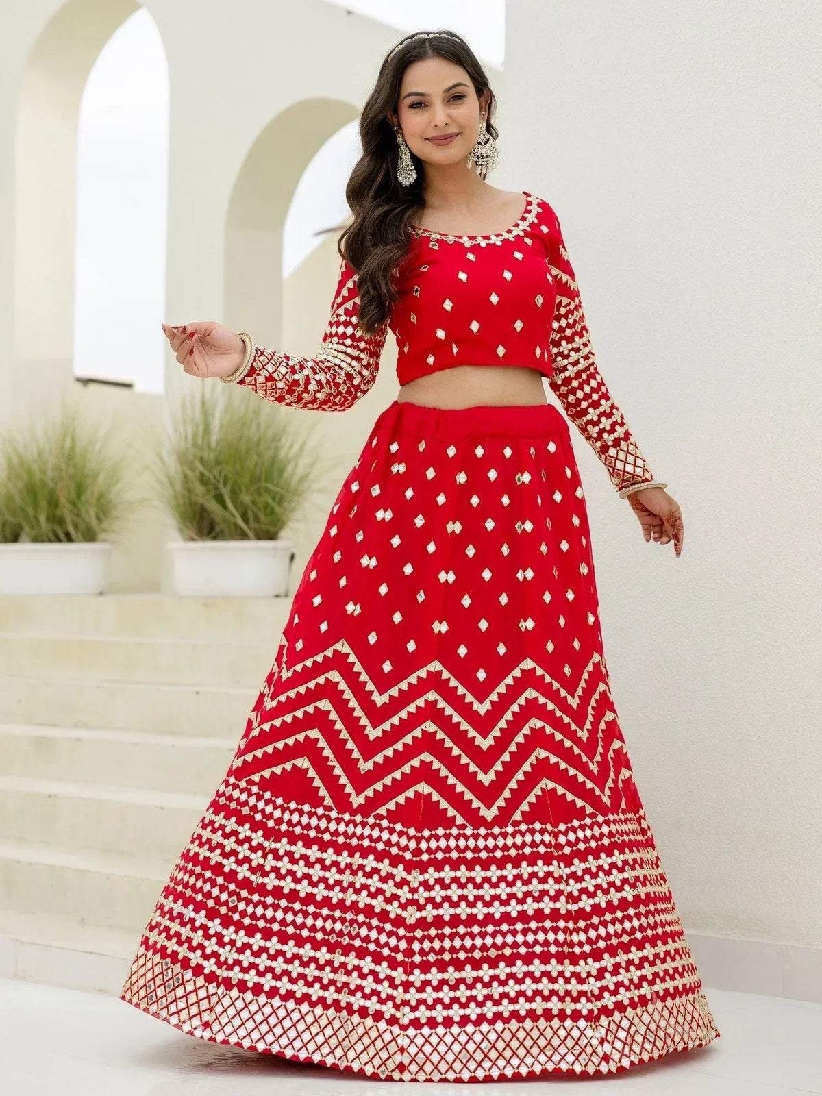 Red embroidered lehenga choli with mirror work, perfect for Indian ethnic wear and festive occasions