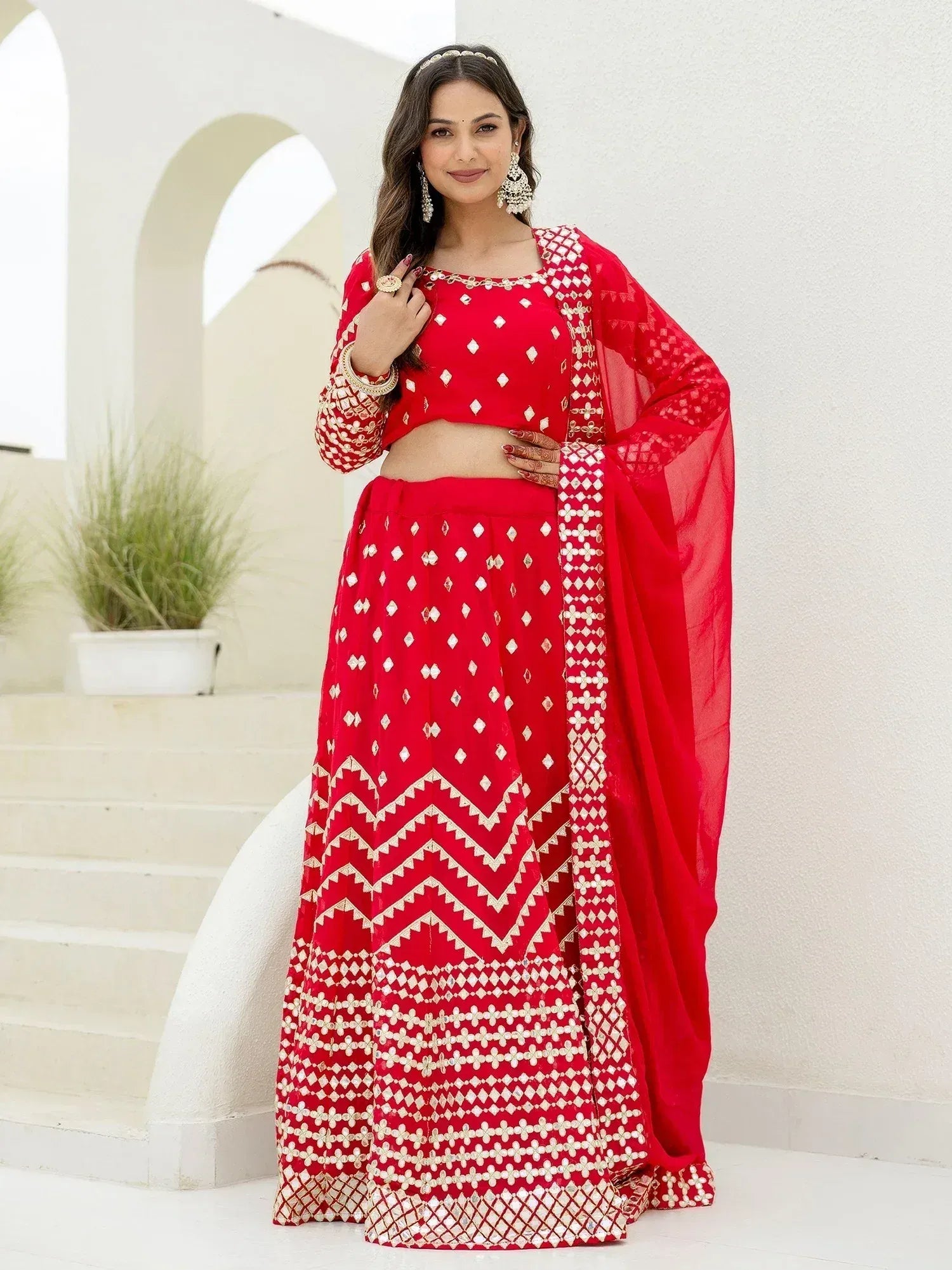 Red embroidered lehenga choli with gold detailing, perfect for Indian ethnic wear and festive occasions.