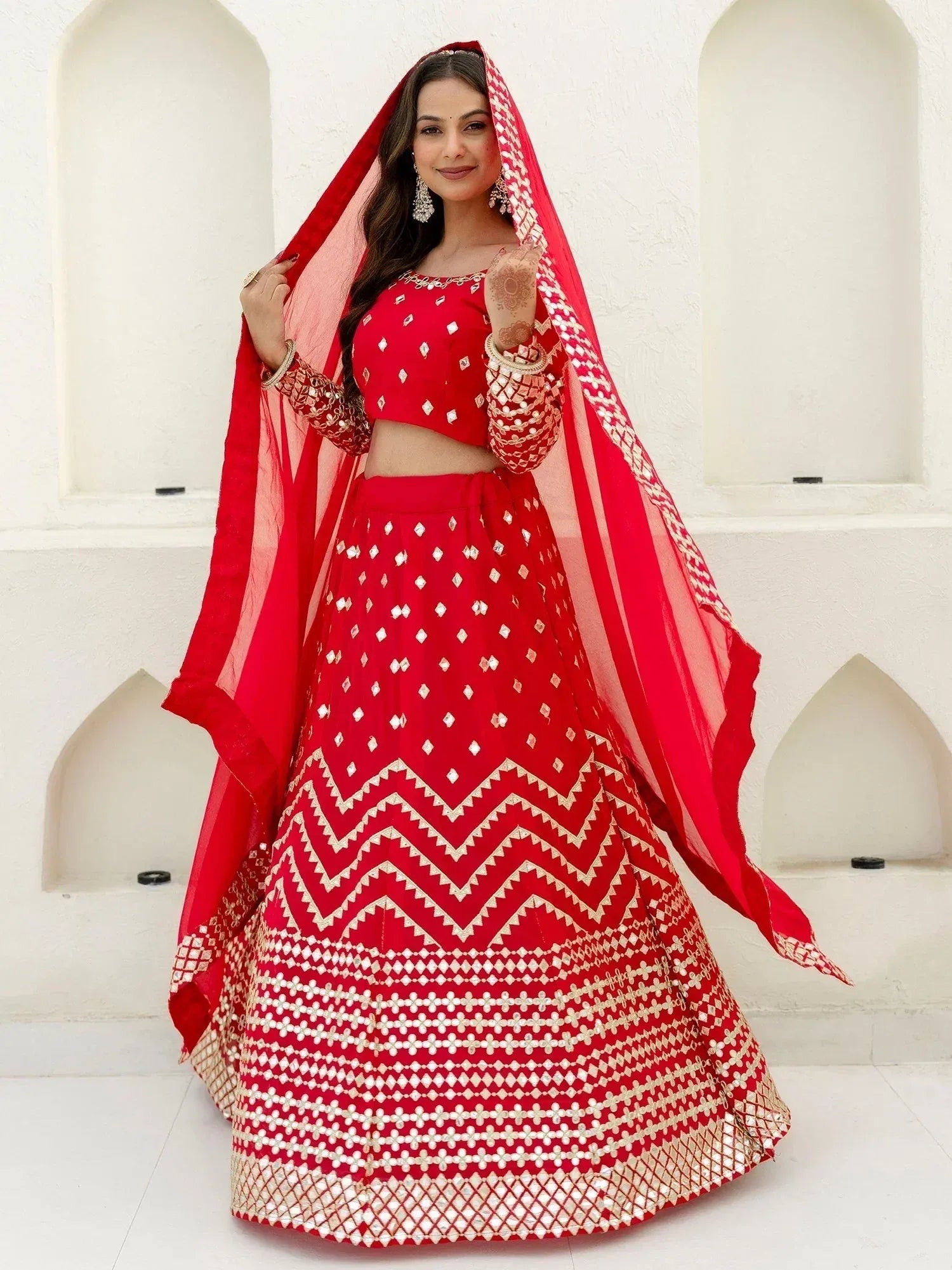 Red designer lehenga choli with gold embroidery and dupatta, perfect for Indian weddings and festive occasions