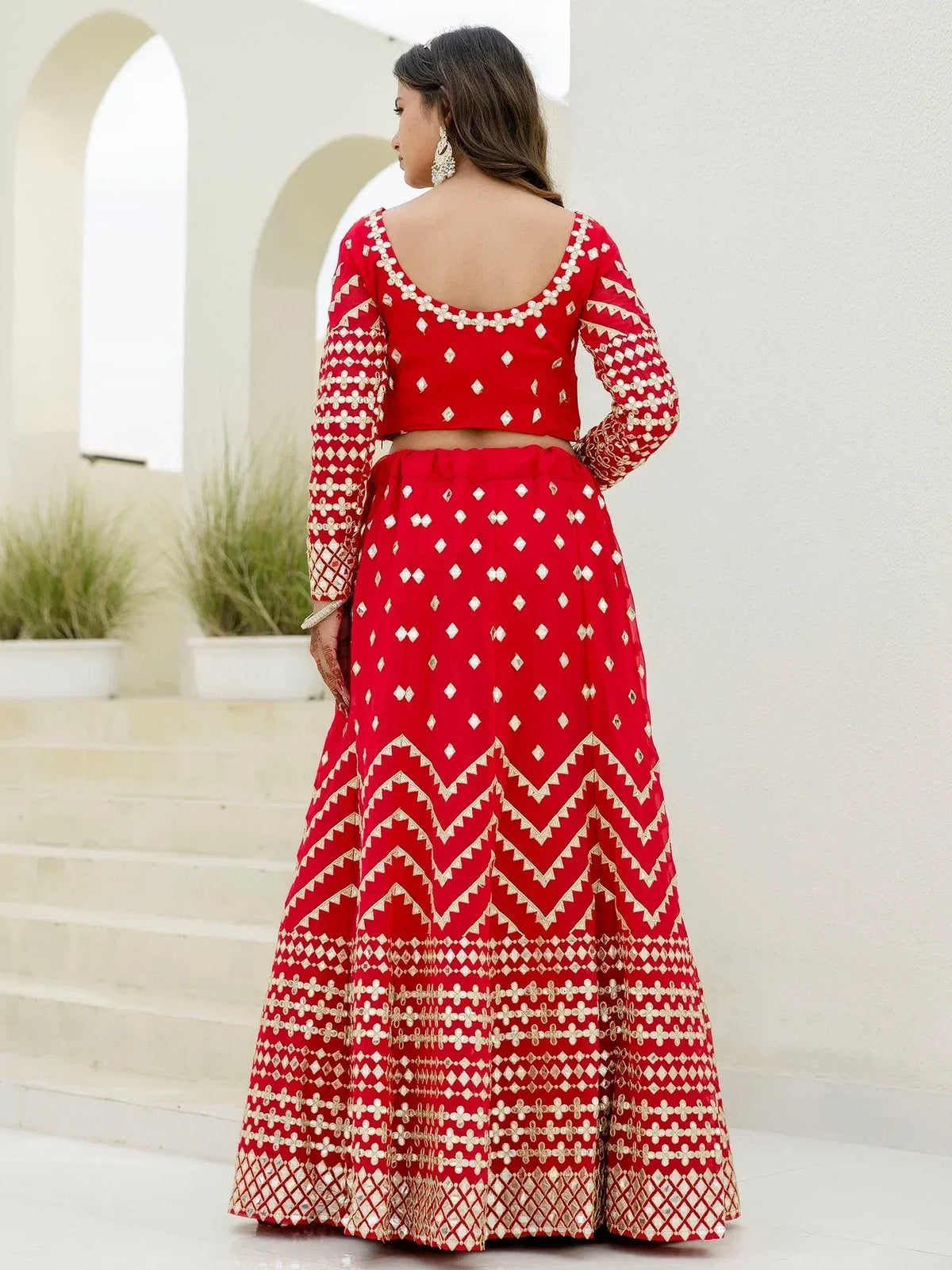 Red embroidered lehenga choli with gold mirror work, back view, ethnic Indian wear