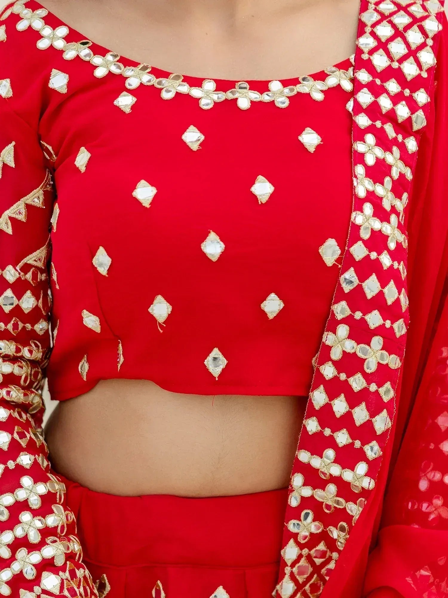 Red mirror-work lehenga choli with gold embroidery, ethnic Indian wear for festive occasions