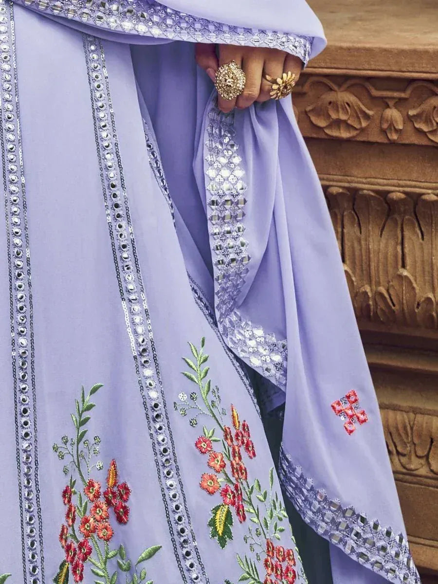 Lavender ethnic salwar kameez with floral embroidery and mirror work, paired with statement rings.