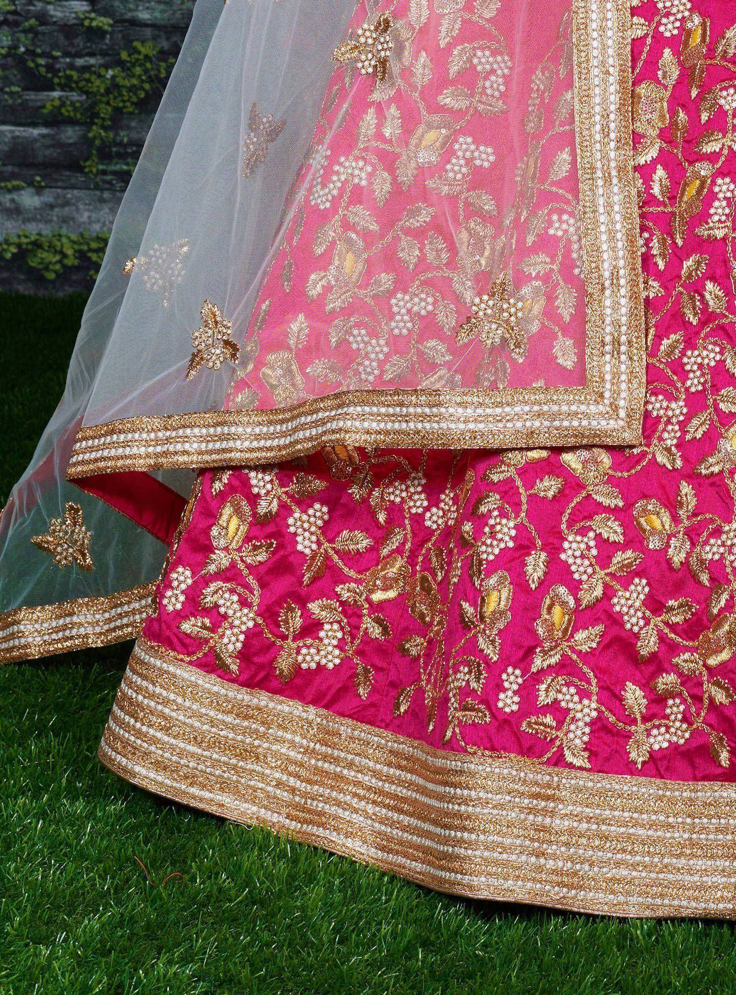 Pink embroidered lehenga with gold floral motifs and sheer dupatta, perfect for Indian ethnic wear.