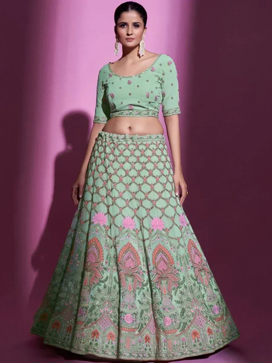 Mint green embroidered lehenga choli with pink floral motifs, perfect for Indian ethnic wear occasions