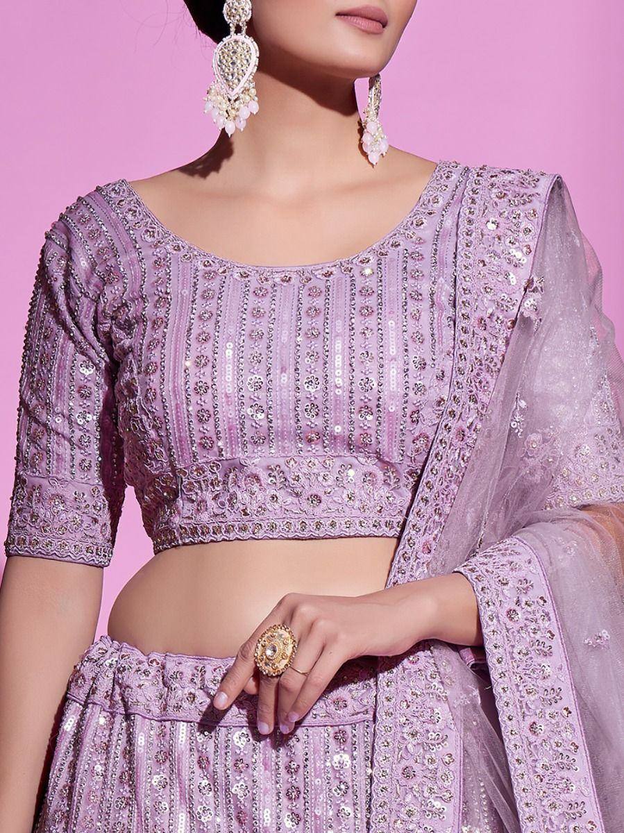 Lavender embroidered lehenga choli with sequin work, sheer dupatta, and statement earrings for Indian ethnic wear