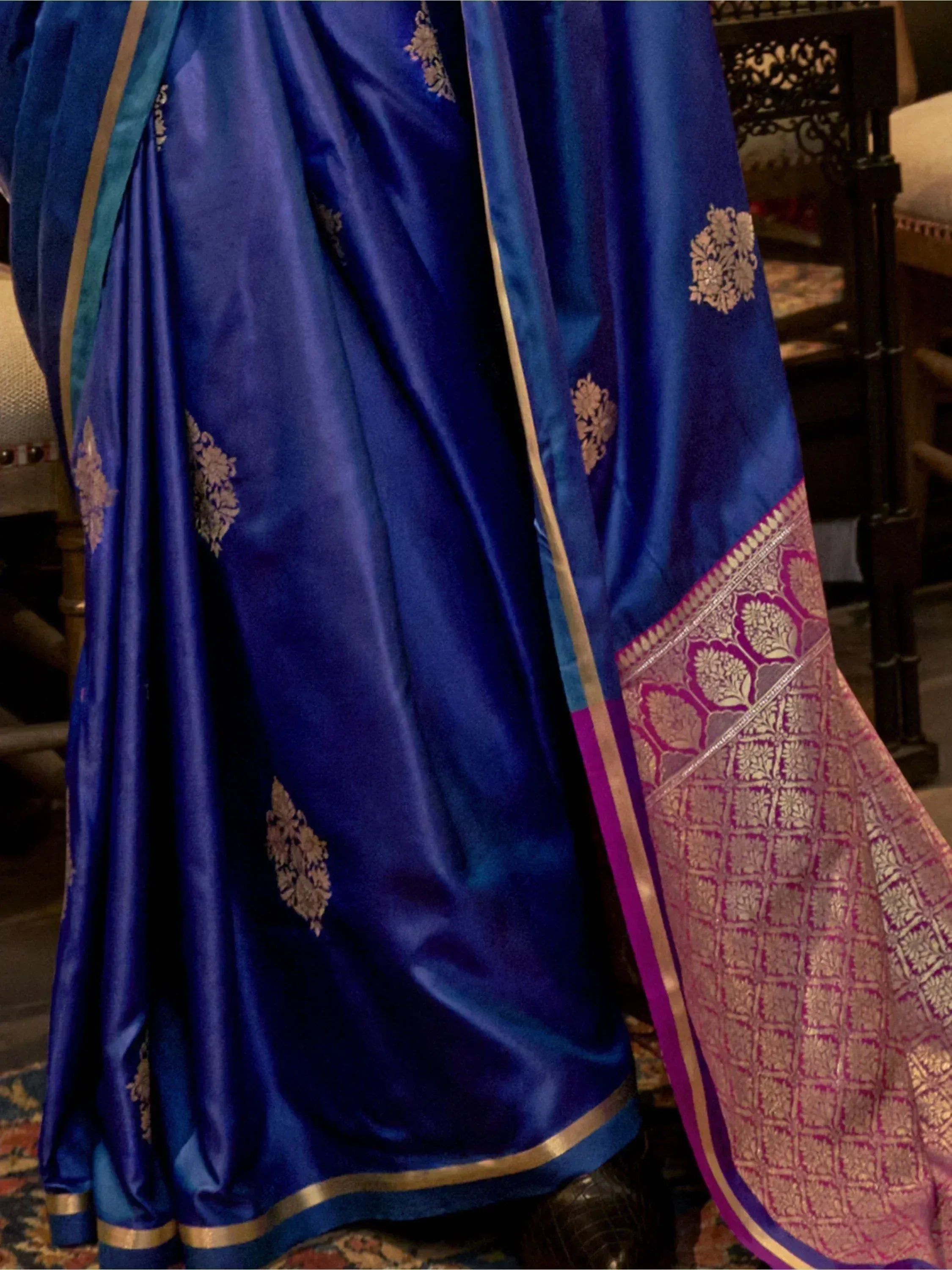 Royal blue silk saree with gold floral motifs and purple border, perfect for Indian ethnic wear occasions
