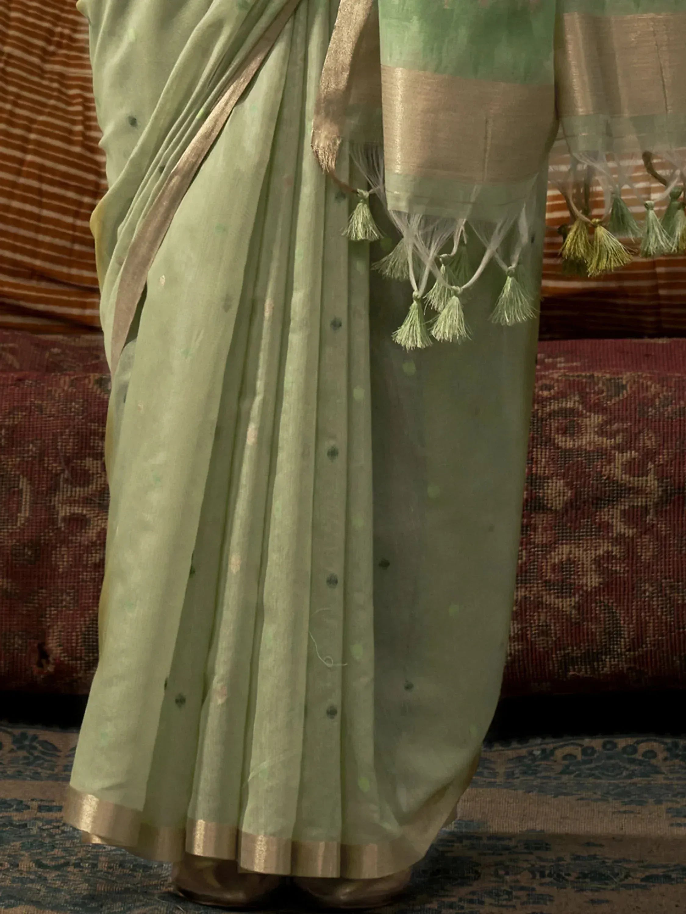 Mint green saree with gold border and tassels, elegant Indian ethnic wear for women