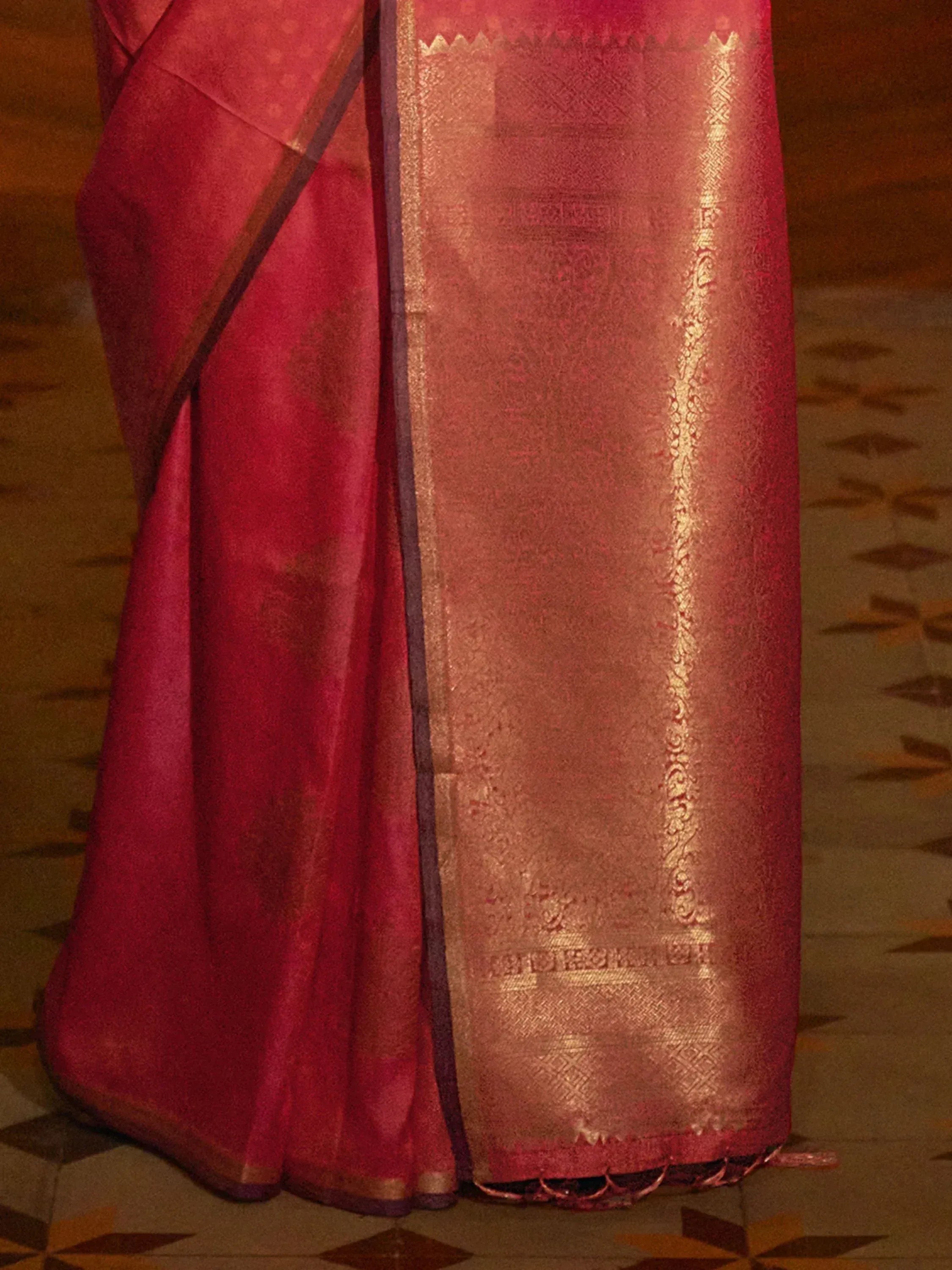 Rich red saree with golden zari border and intricate woven patterns, ideal for ethnic occasions
