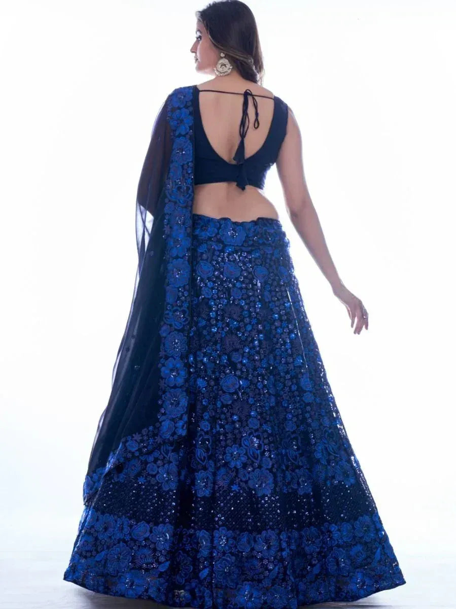 Blue embroidered lehenga choli with floral detailing and sheer dupatta, perfect for Indian ethnic wear