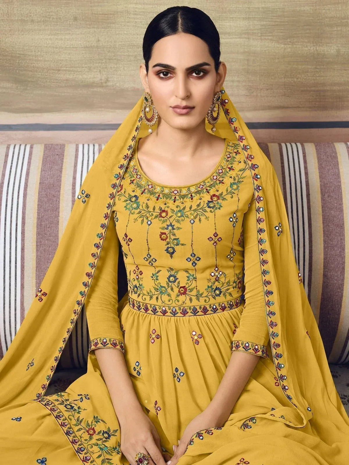 Yellow embroidered salwar kameez with floral motifs and matching dupatta, ideal for ethnic occasions