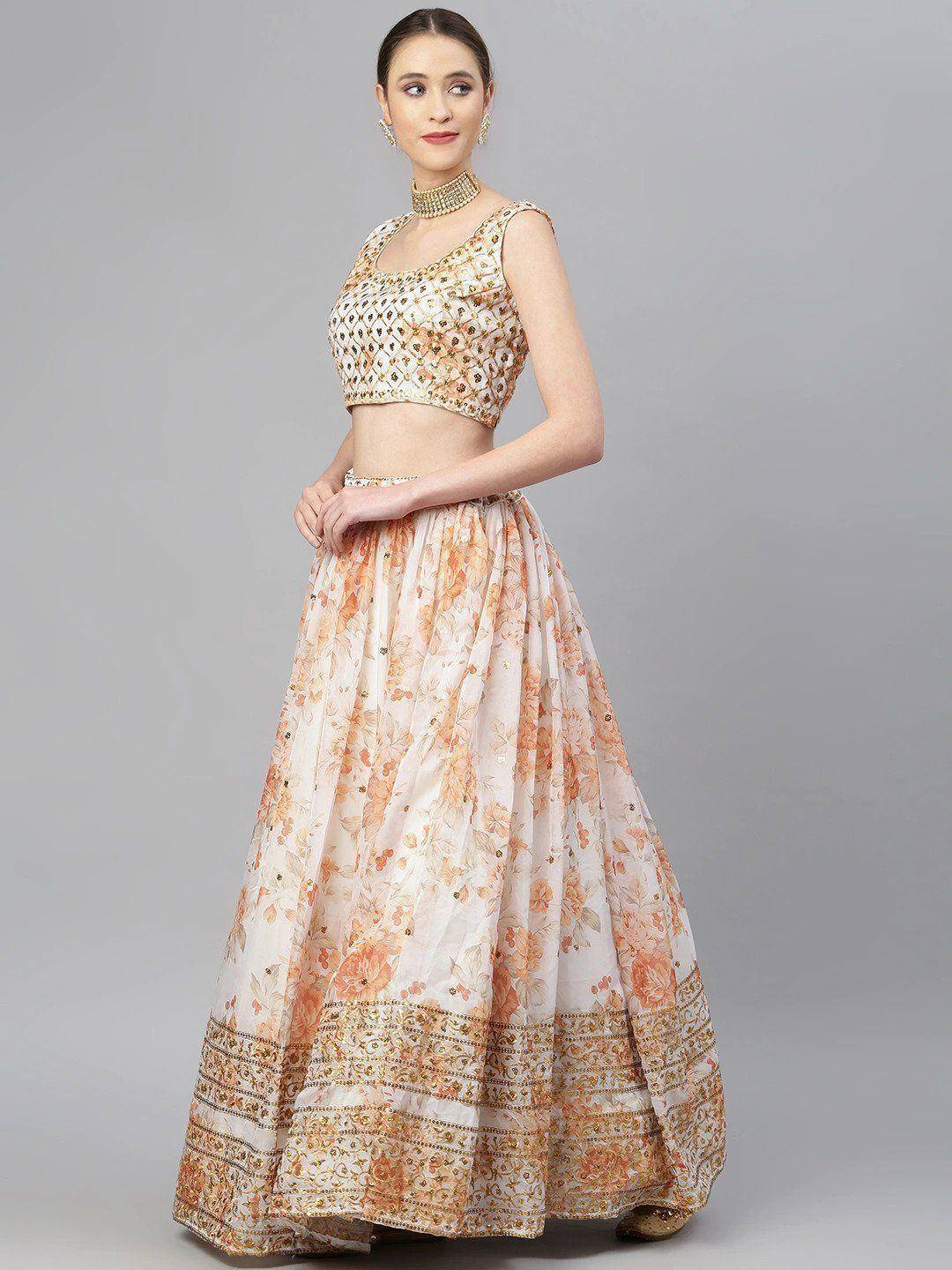 Elegant peach floral lehenga choli with gold embroidery, perfect for Indian weddings and festive occasions.