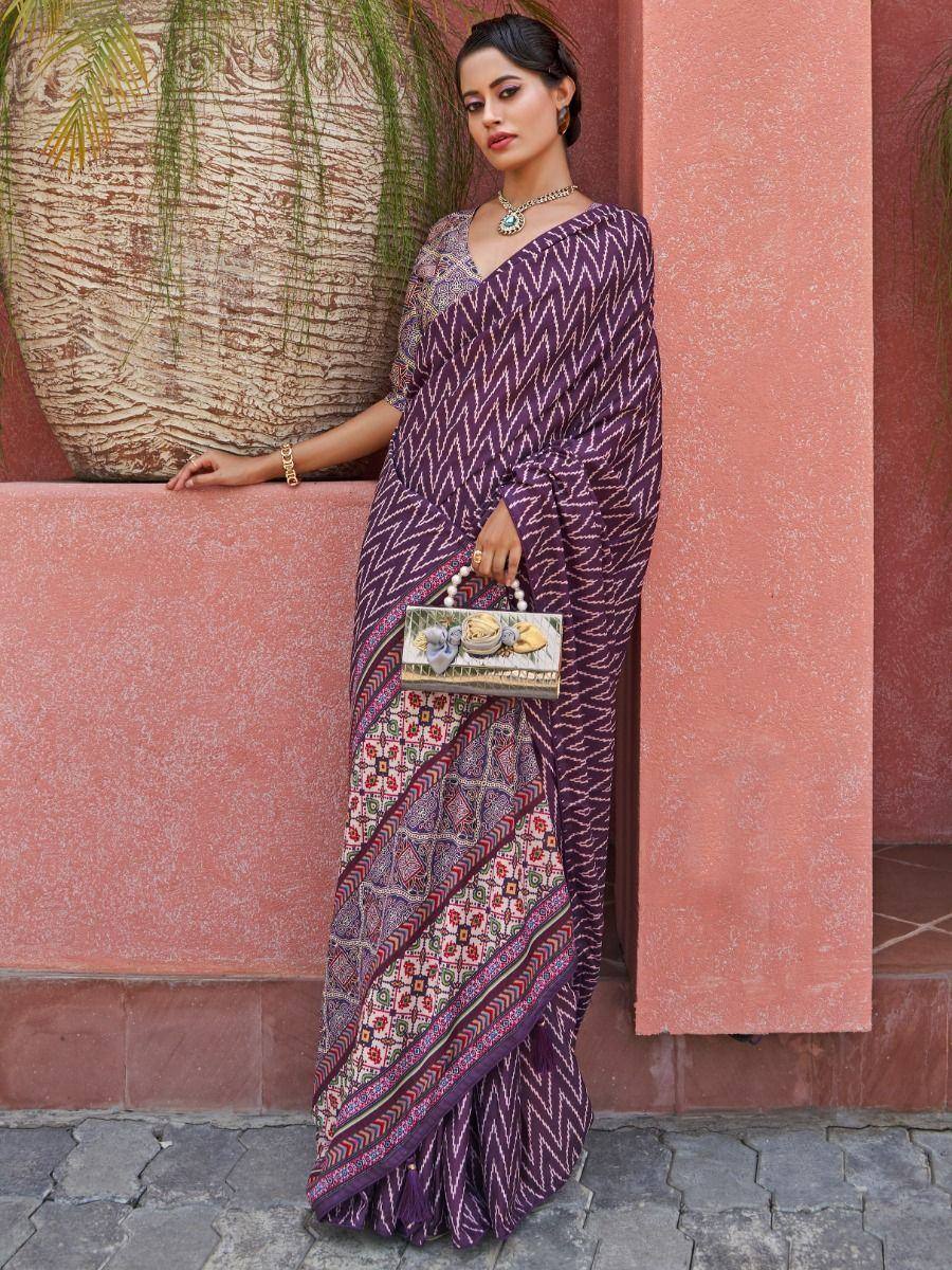 Purple printed saree with ethnic motifs, perfect for Indian occasions and festive wear.