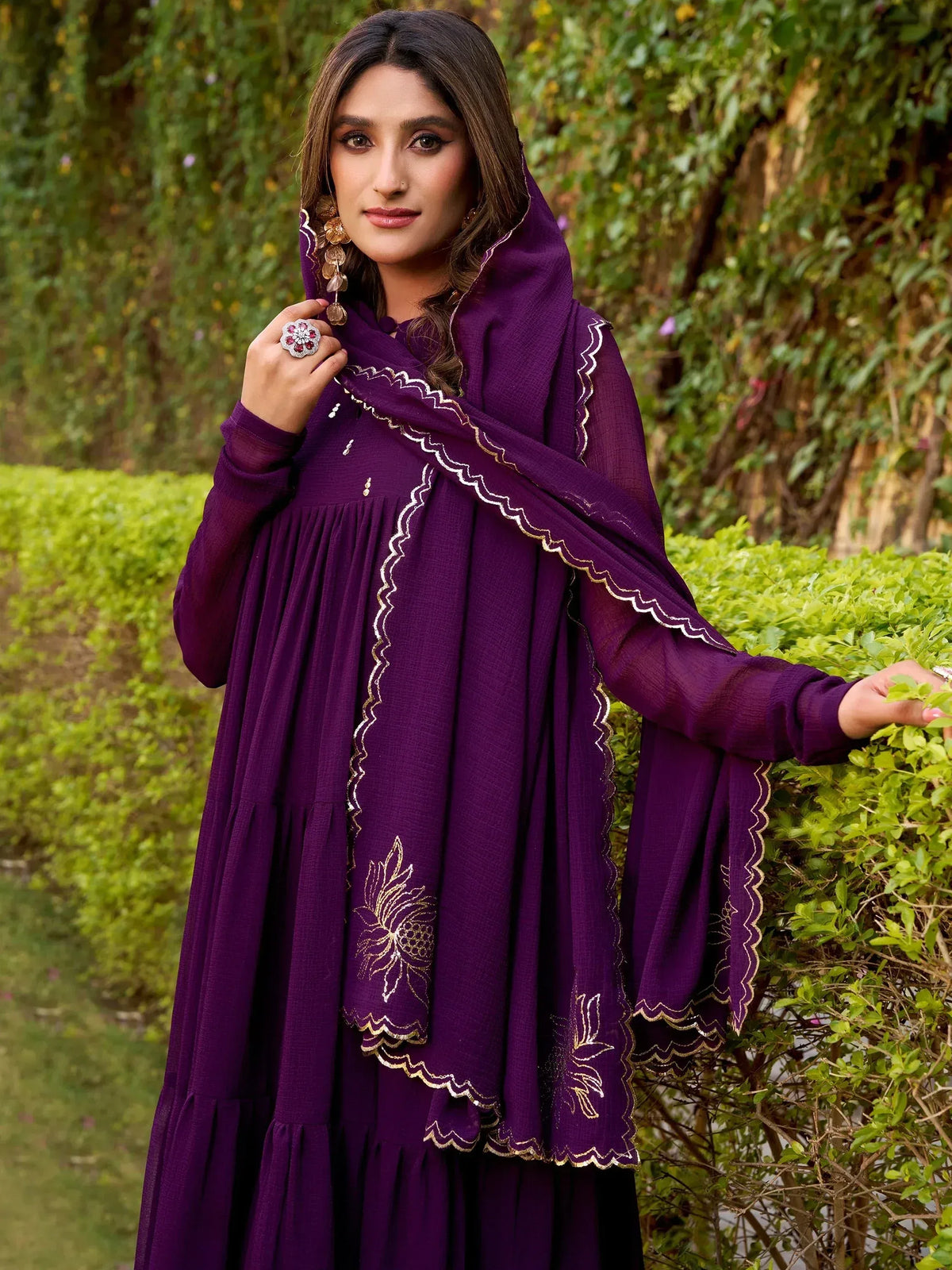 Purple ethnic gown with gold embroidery and scalloped dupatta, perfect for Indian occasions