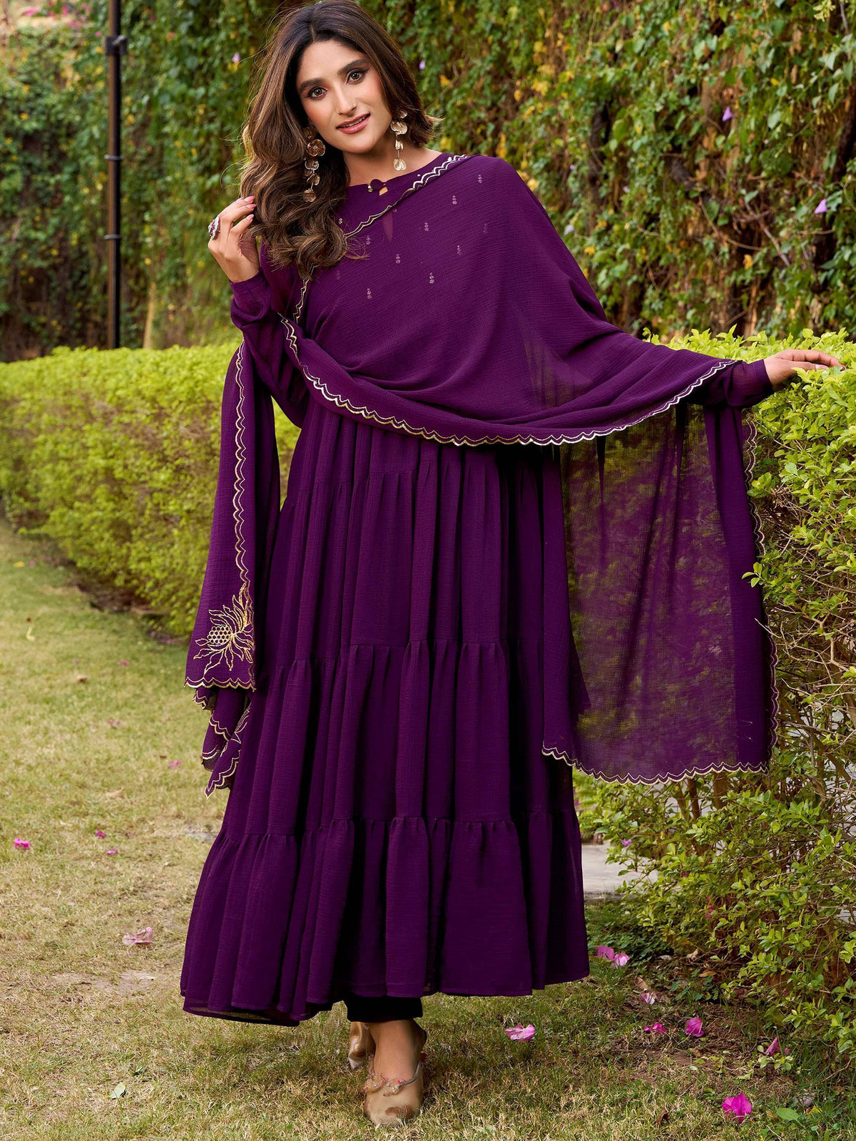 Purple tiered ethnic gown with gold embroidery and scalloped dupatta, perfect for festive occasions