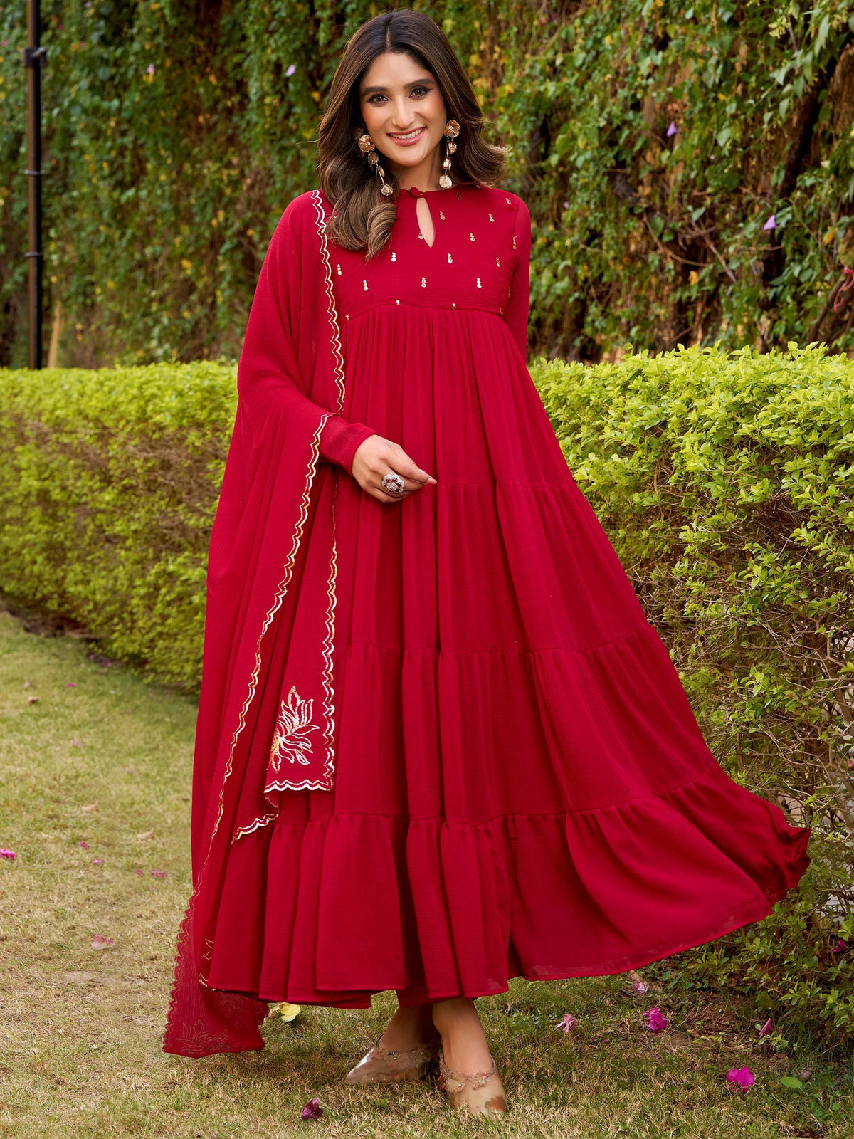 Red ethnic gown with gold embroidery, tiered skirt, and flared sleeves for women