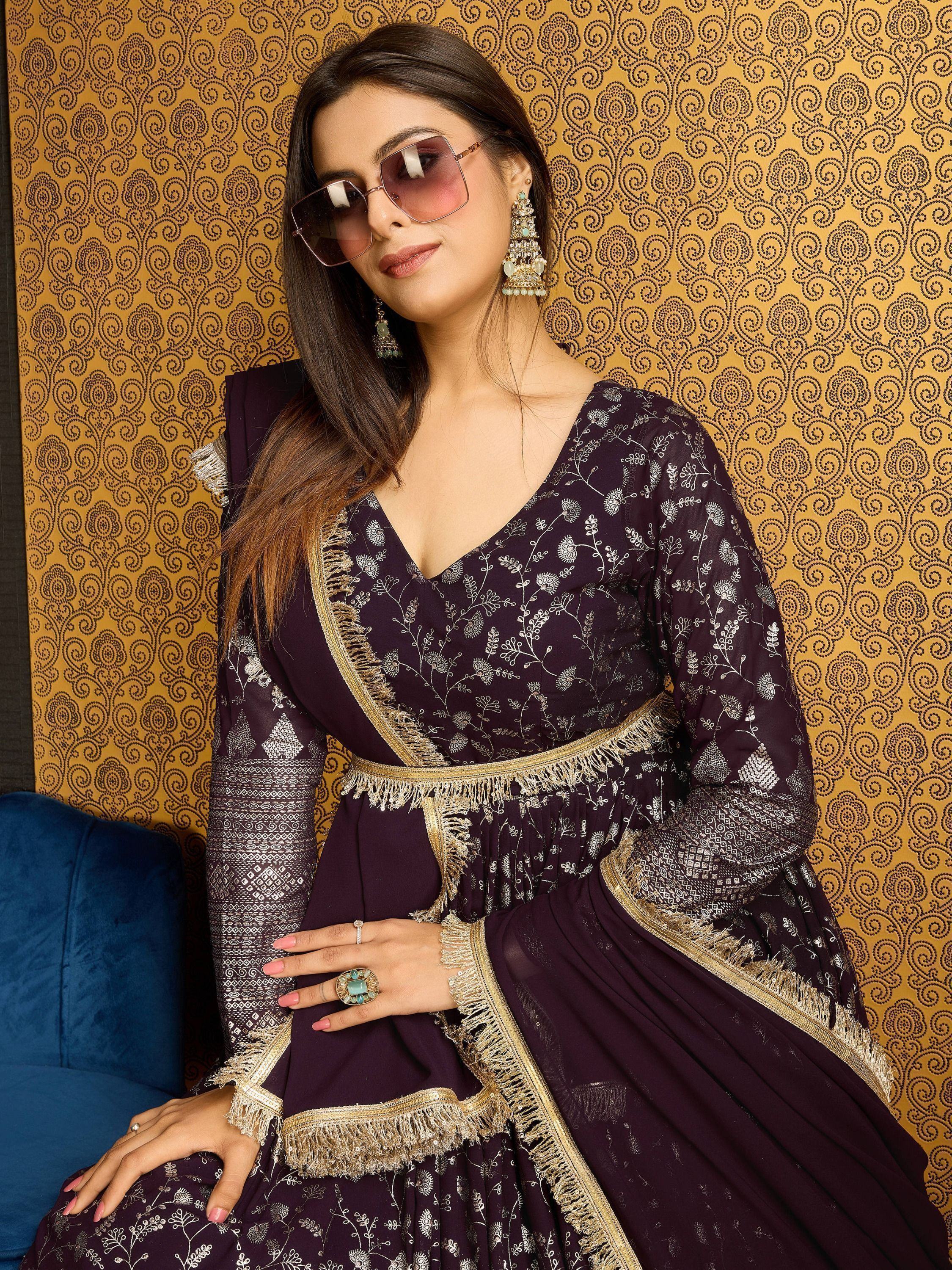 Woman in wine georgette gown with silver foil work, dupatta, and ethnic jewelry
