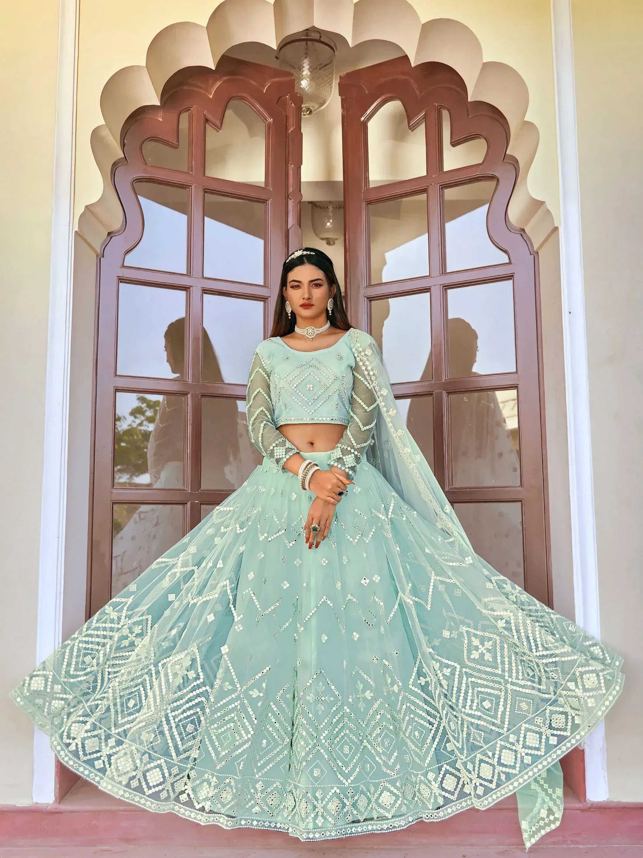 Mint green designer lehenga choli with mirror work, perfect for Indian ethnic wear and festive occasions