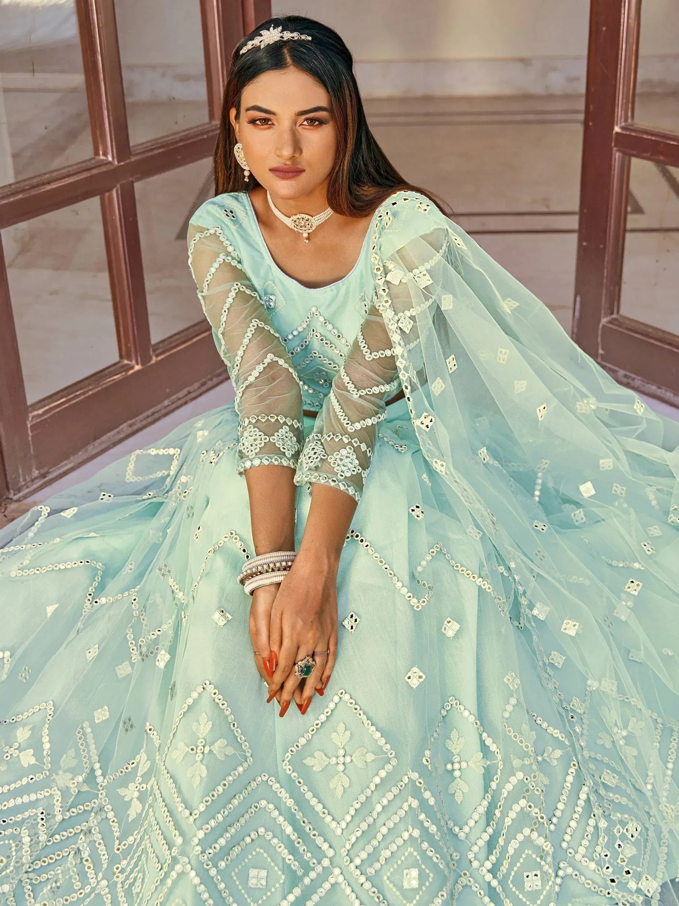 Mint green designer lehenga choli with mirror work and sheer sleeves, perfect for Indian ethnic wear