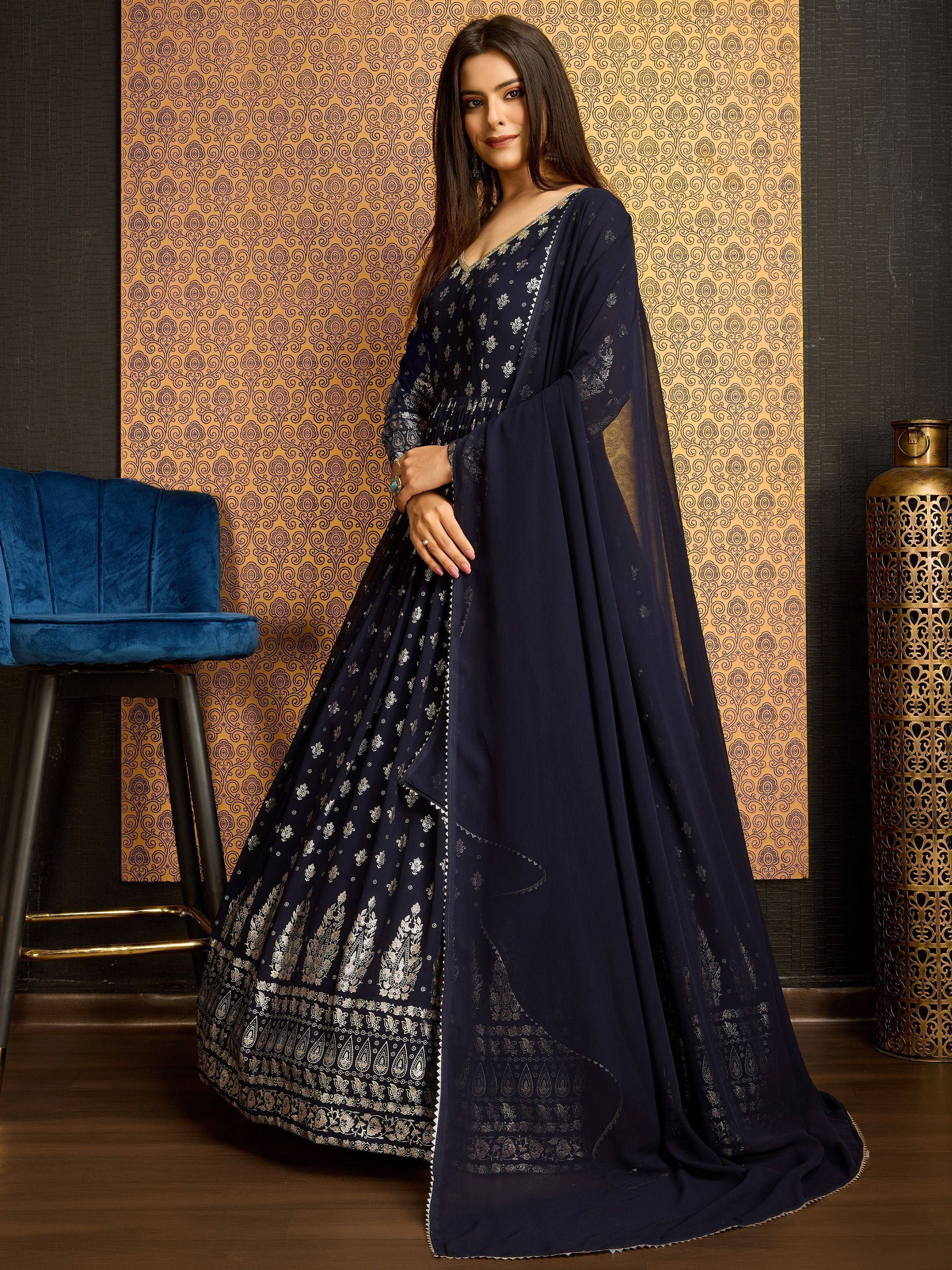 Navy blue designer lehenga choli with silver embroidery and sheer dupatta, perfect for Indian ethnic occasions.