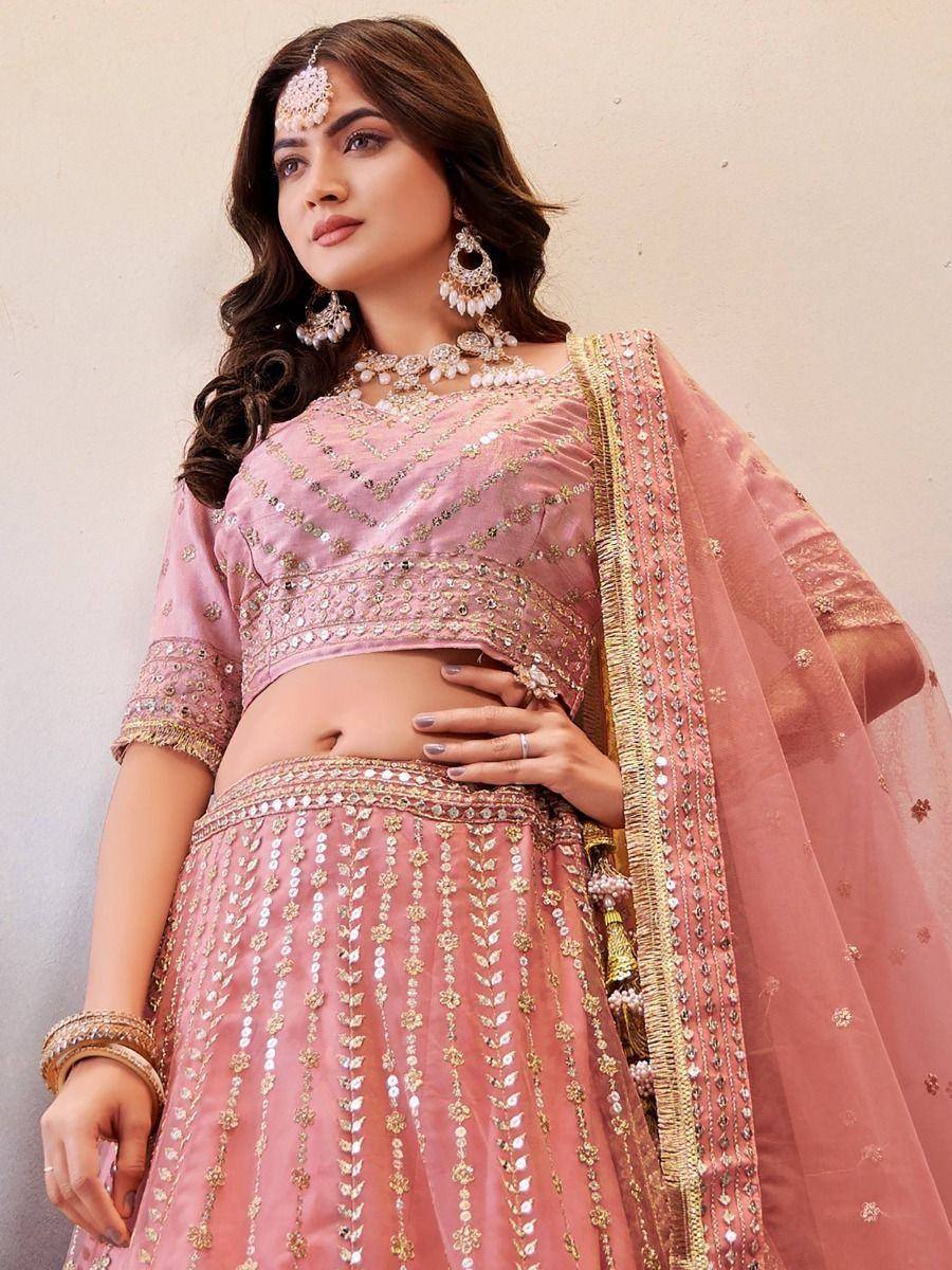 Pink designer lehenga choli with gold embroidery and mirror work, perfect for weddings and festive occasions