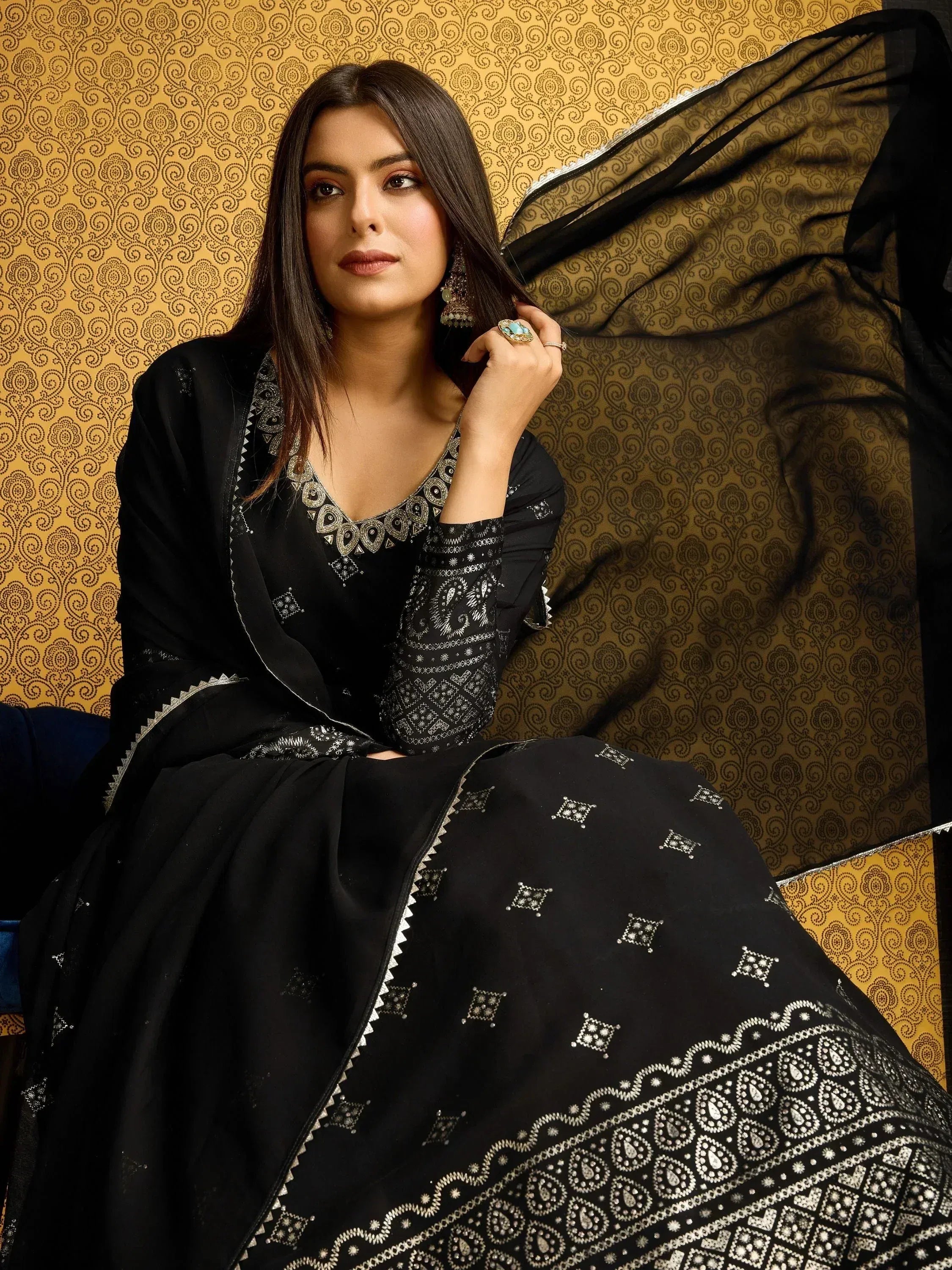 Black embroidered salwar kameez with silver detailing, perfect for ethnic wear and festive occasions.