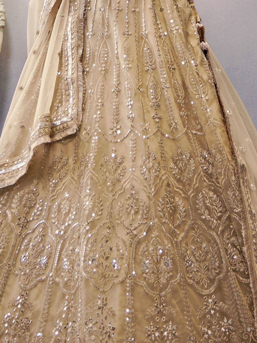 Beige designer lehenga choli with intricate gold embroidery and sequin work, perfect for weddings