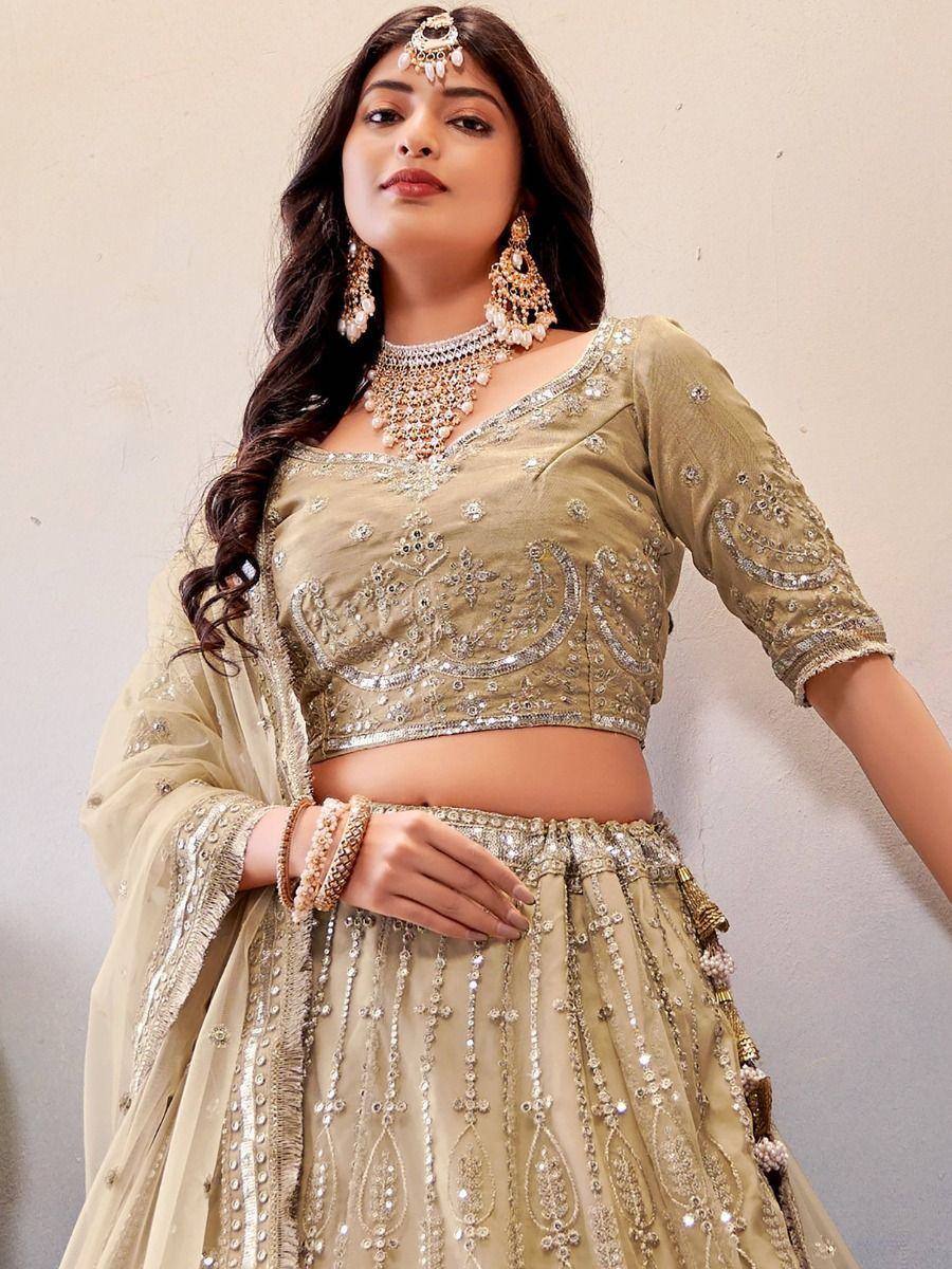 Elegant olive green embroidered lehenga choli with heavy embellishments and matching jewelry