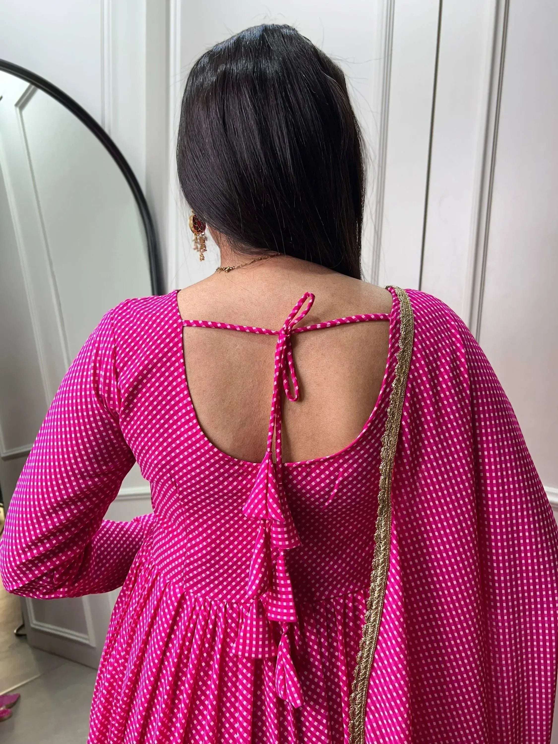 Pink gingham ethnic gown with back tie detail and gold trim, perfect for Indian occasions