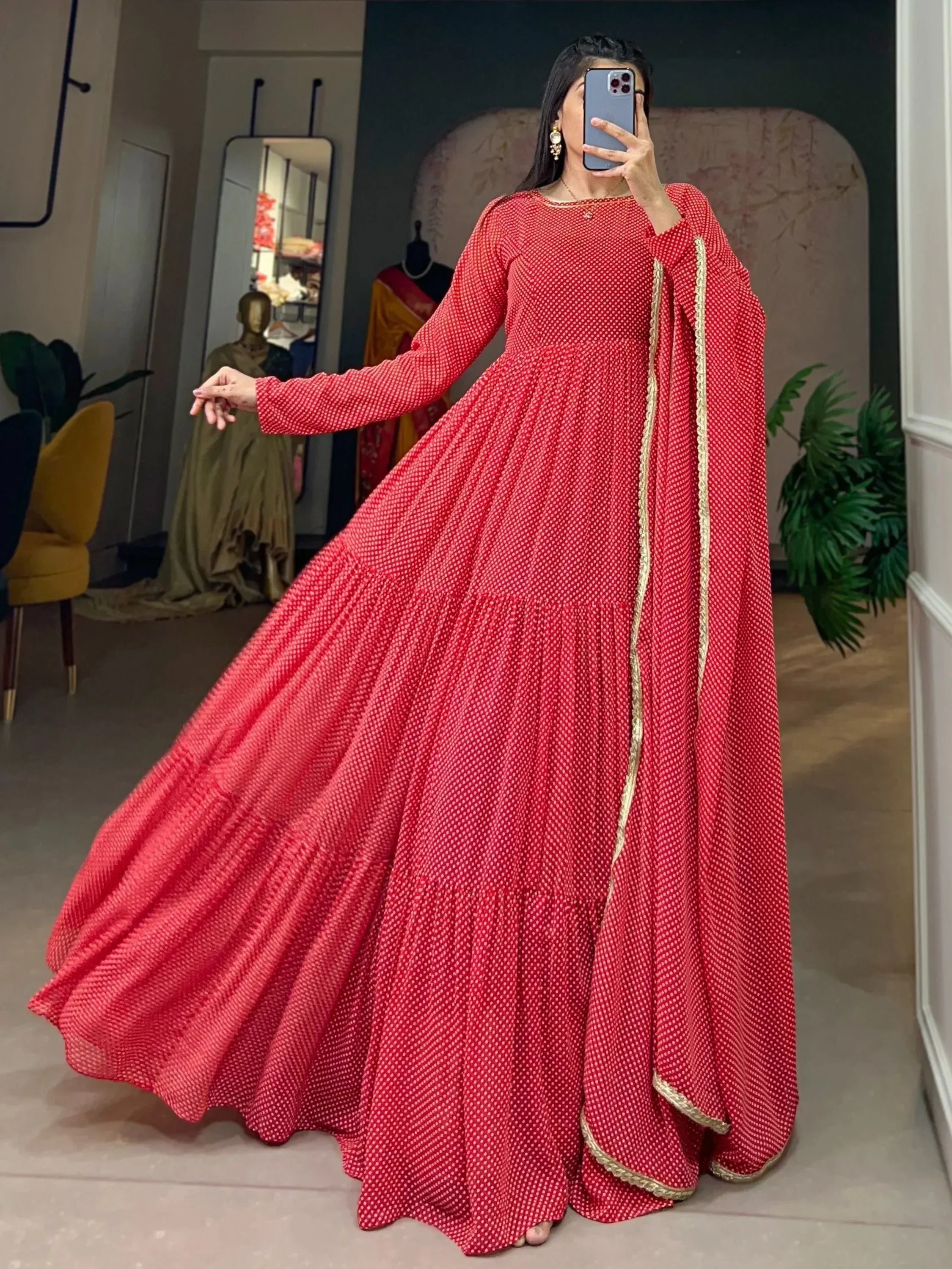 Red polka dot ethnic gown with gold trim, long sleeves, flared skirt, perfect for Indian occasions