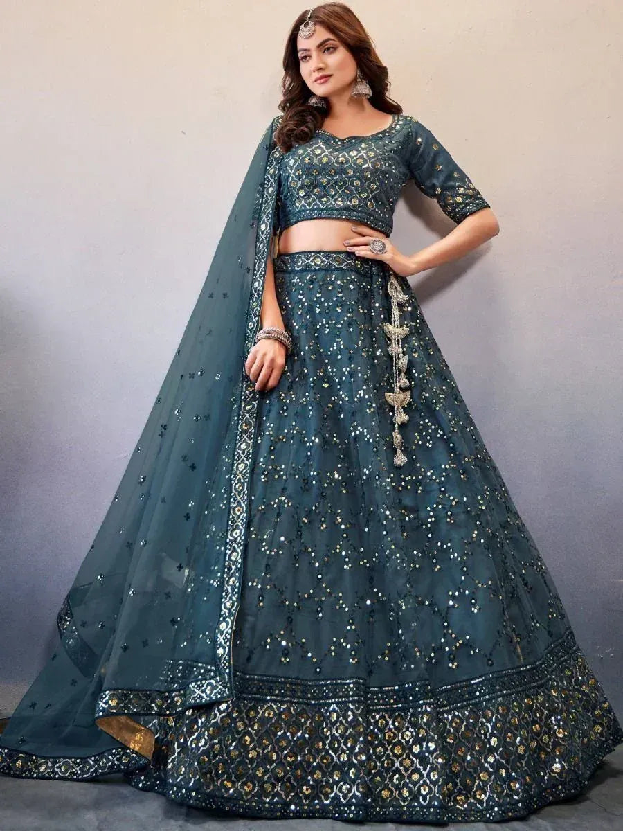 Teal designer lehenga choli with gold embroidery and sequins, perfect for Indian weddings and festive occasions.