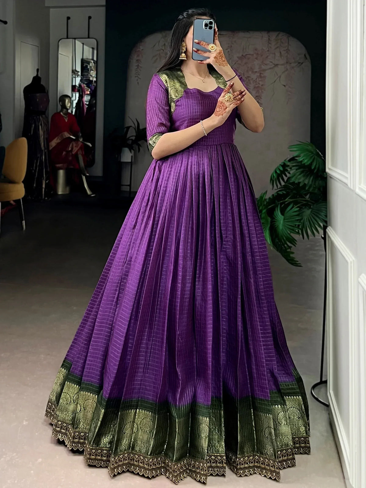 Purple and green ethnic gown with pleated skirt and gold embroidery, perfect for Indian occasions