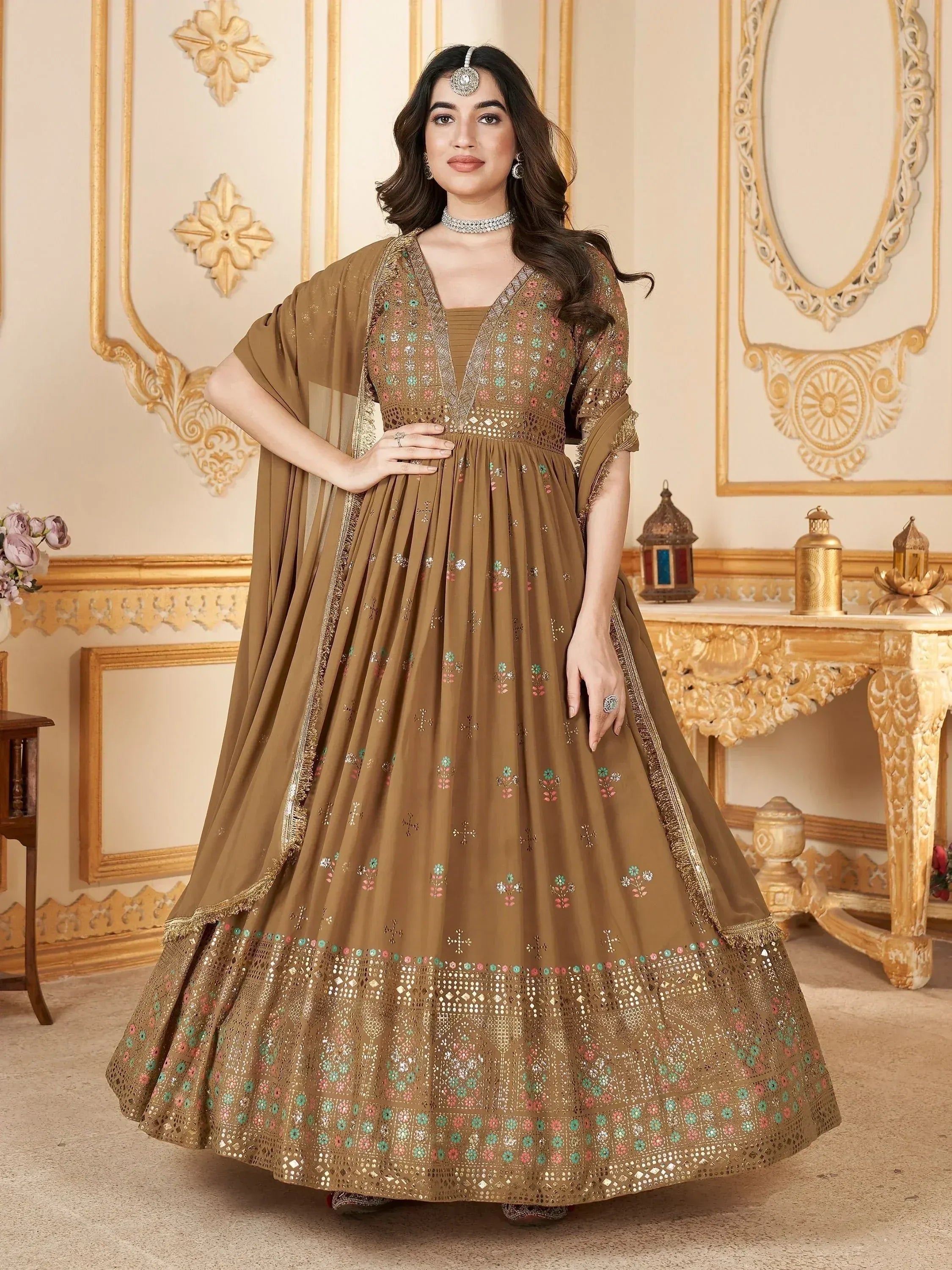 Elegant brown ethnic anarkali gown with mirror work and floral embroidery, perfect for Indian weddings and festive occasions.