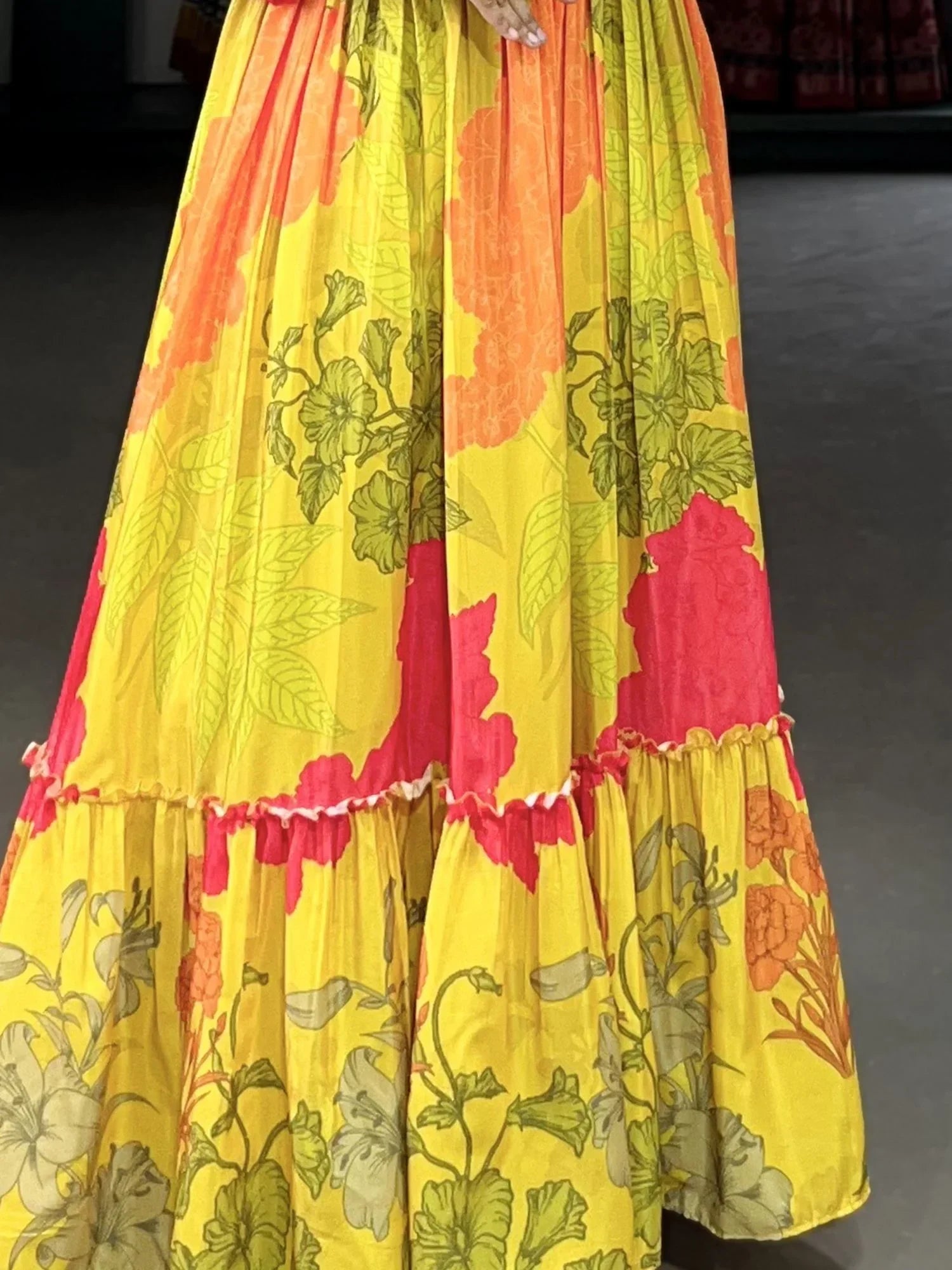Yellow floral printed ethnic skirt with orange and green flower patterns, pleated design