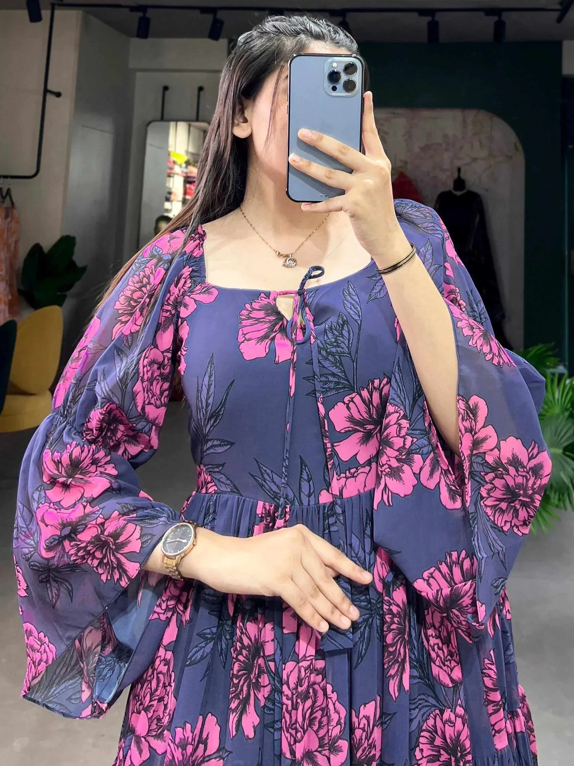 Woman wearing navy blue floral print ethnic gown with puff sleeves, perfect for Indian occasions