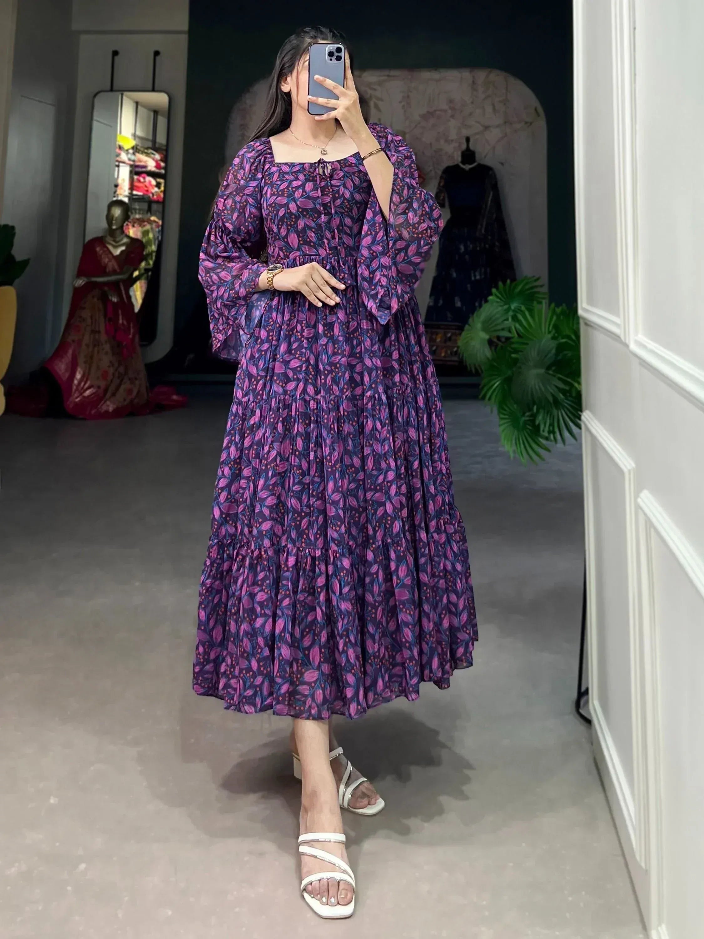 Purple floral print ethnic gown with puff sleeves and tiered skirt, styled with white heels