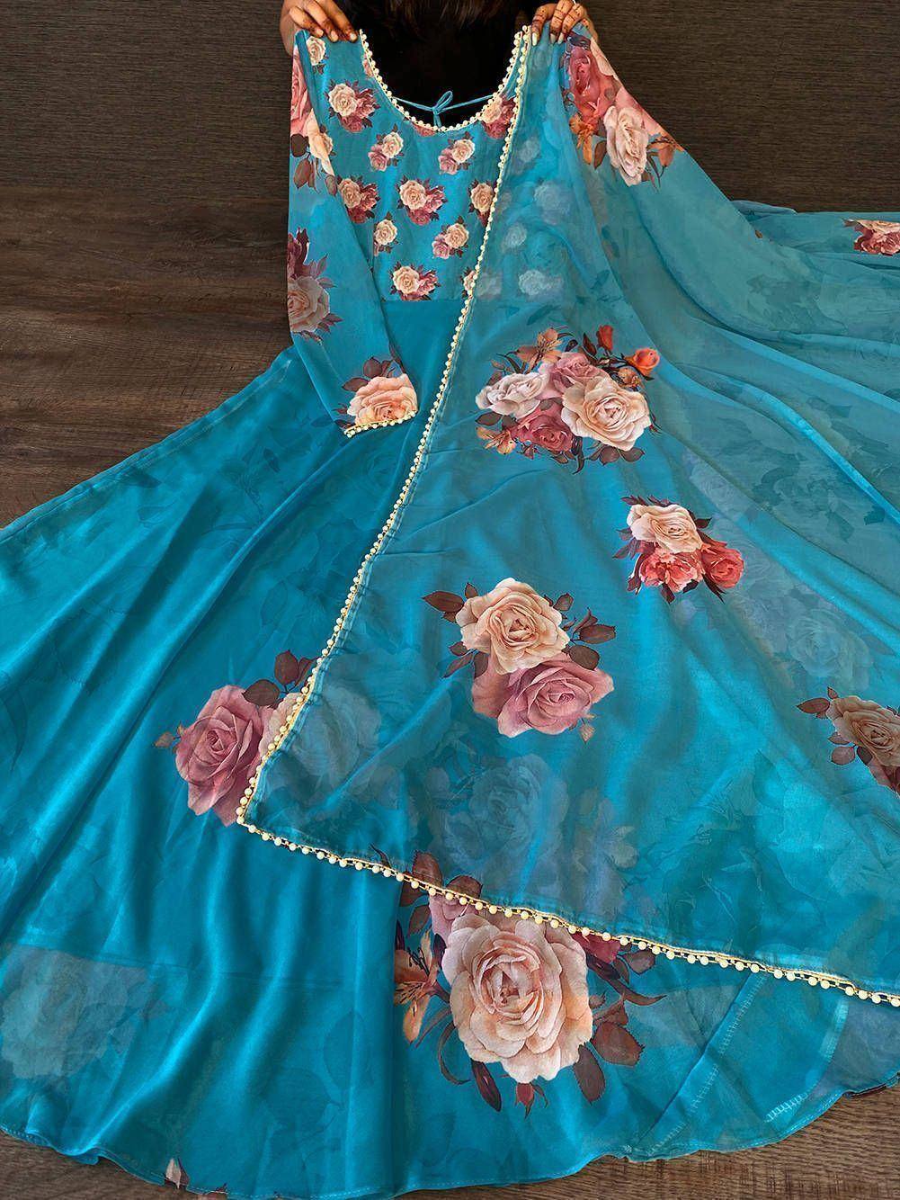 Turquoise floral print ethnic gown with rose motifs and gold trim, perfect for Indian occasions