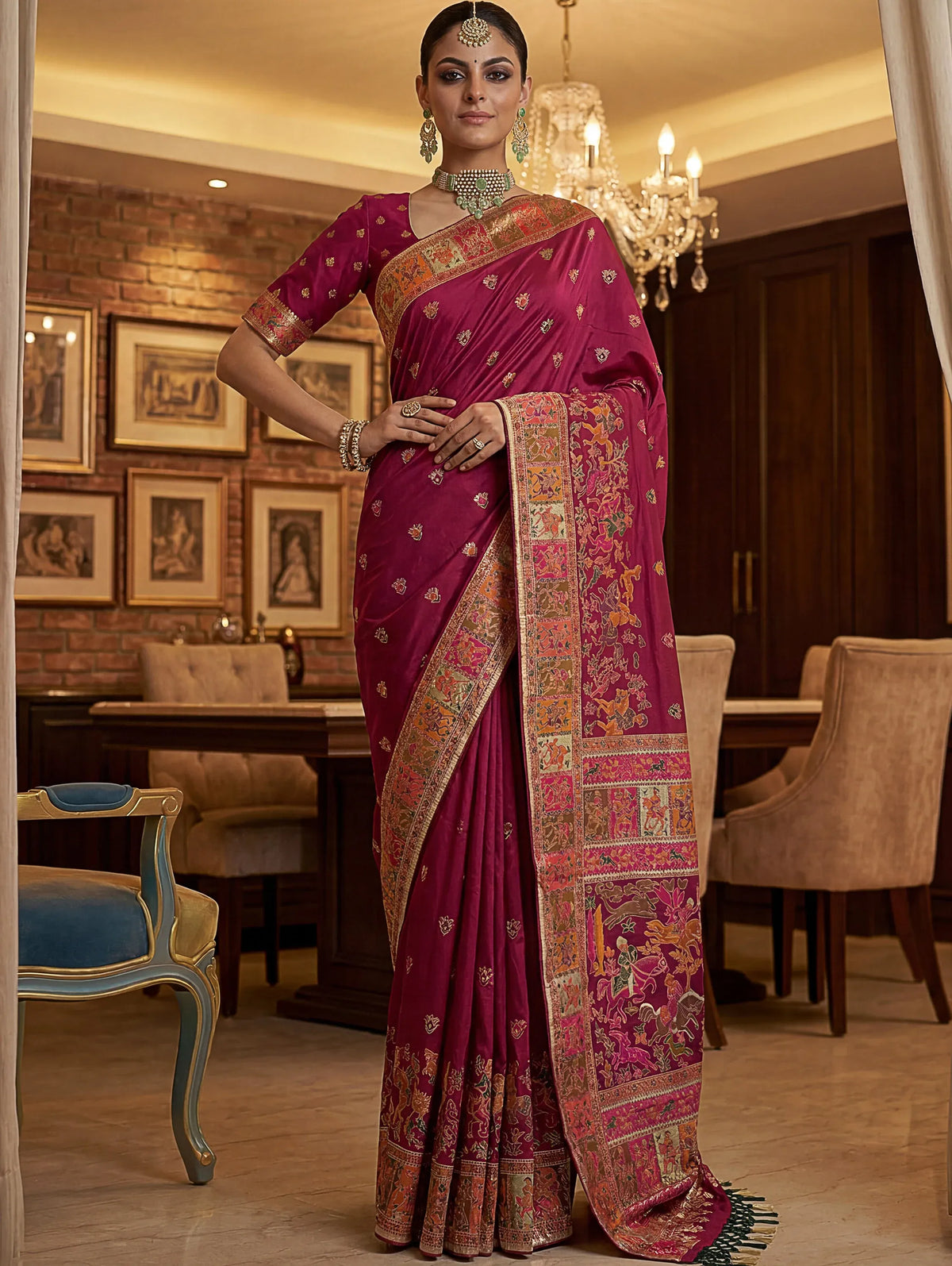 Woman wearing a magenta designer Banarasi silk saree with gold zari embroidery
