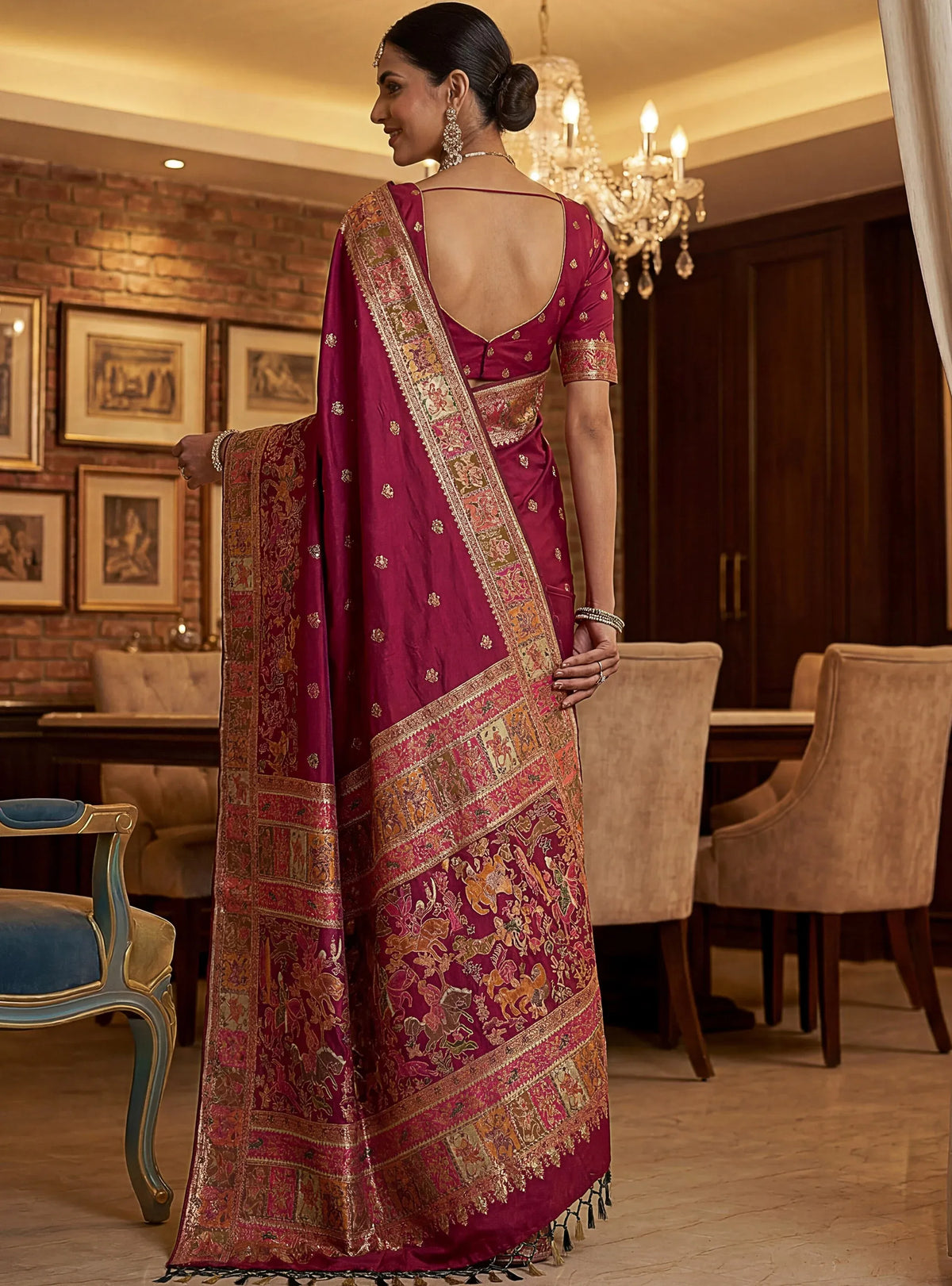 Woman wearing a magenta Banarasi silk saree with gold zari embroidery